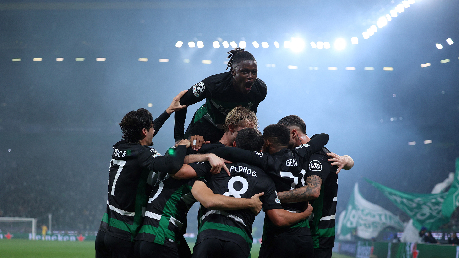 Sporting Lisbon's players celebrate after Swedish forward #09 Viktor Gyokeres scored his team's fourth goal during the UEFA Champions League, league phase day 4 football match between Sporting Lisbon and Manchester City at the Jose Alvalade stadium in Lisbon on November 5, 2024.