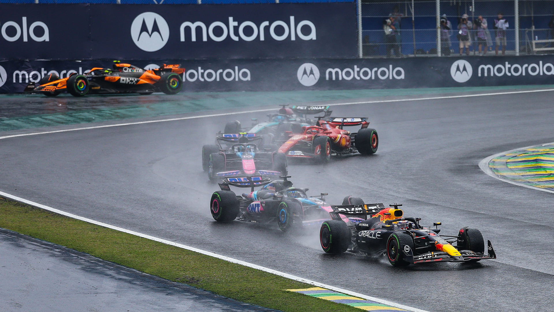 Max Verstappen of the Netherlands driving the (1) Oracle Red Bull Racing RB20 on track leads the field after the Safety Car restart, as Lando Norris of Great Britain driving the (4) McLaren MCL38 Mercedes on track runs off the track in the background during the F1 Grand Prix of Brazil at Autodromo Jose Carlos Pace on November 3, 2024 in Sao Paulo, Brazil.