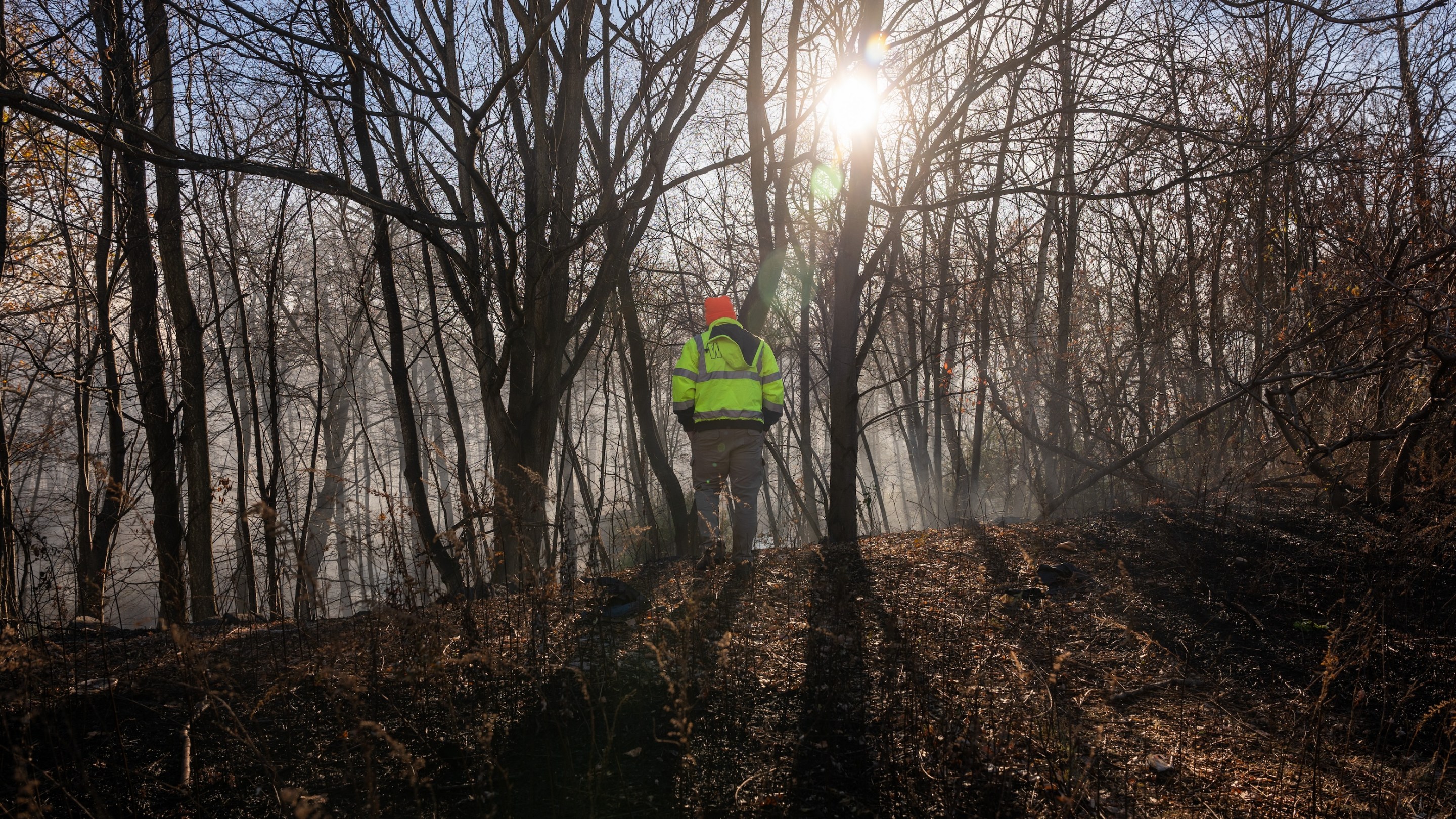 Firefighters take a break from battling a series of brush fires on November 9, 2024 outside of Pompton Lakes, New Jersey.