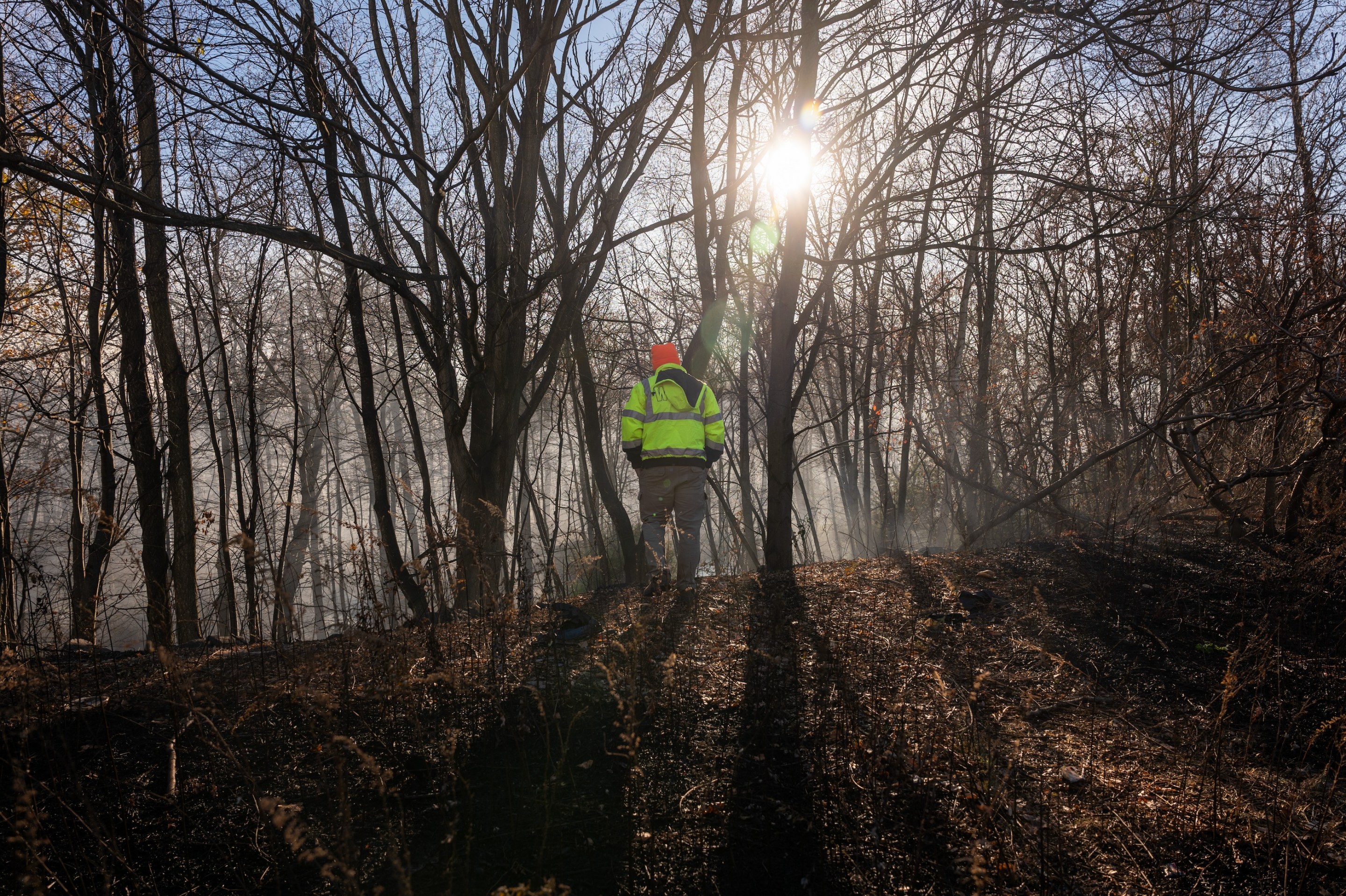 Firefighters take a break from battling a series of brush fires on November 9, 2024 outside of Pompton Lakes, New Jersey.