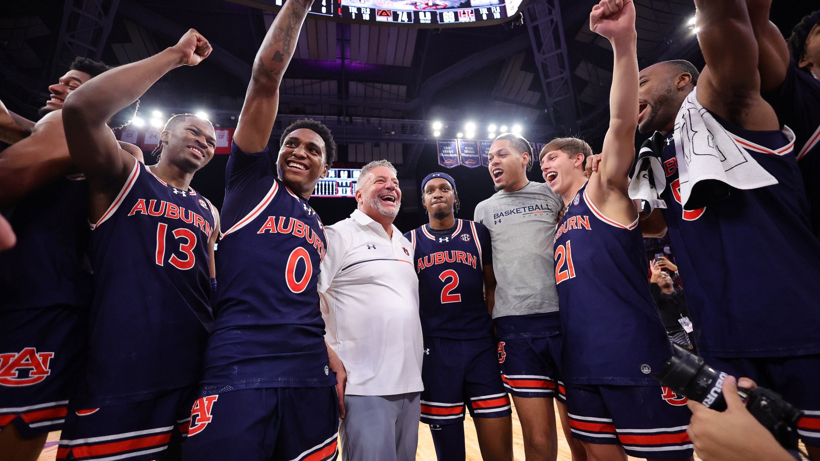 Members of the Auburn Tigers celebrate their 74-69 victory over the Houston Cougars on November 10.