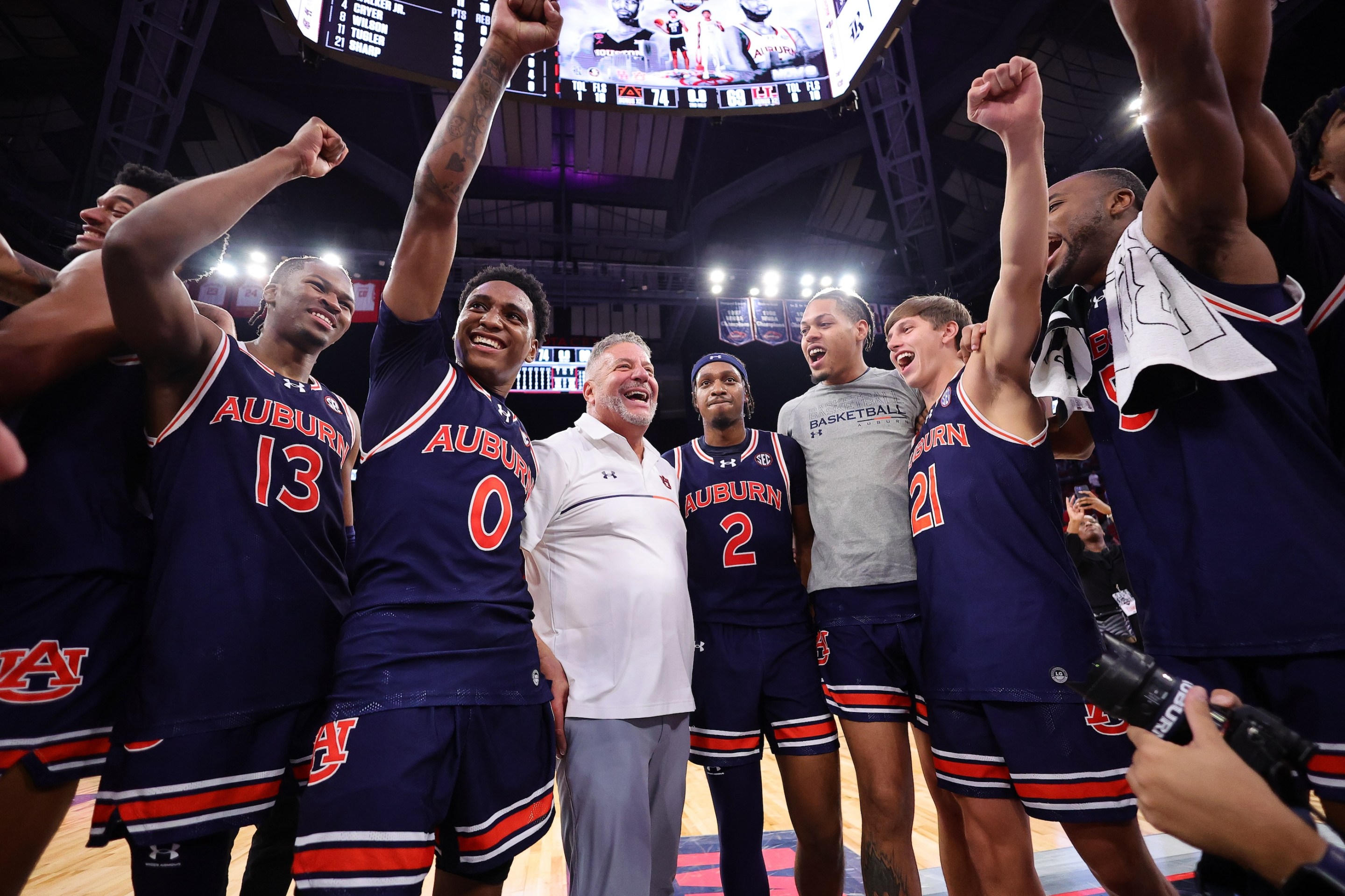 Members of the Auburn Tigers celebrate their 74-69 victory over the Houston Cougars on November 10.