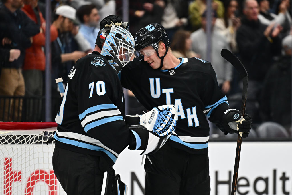 Olli Maatta #2 of the Utah Hockey Club celebrates with goaltender Karel Vejmelka