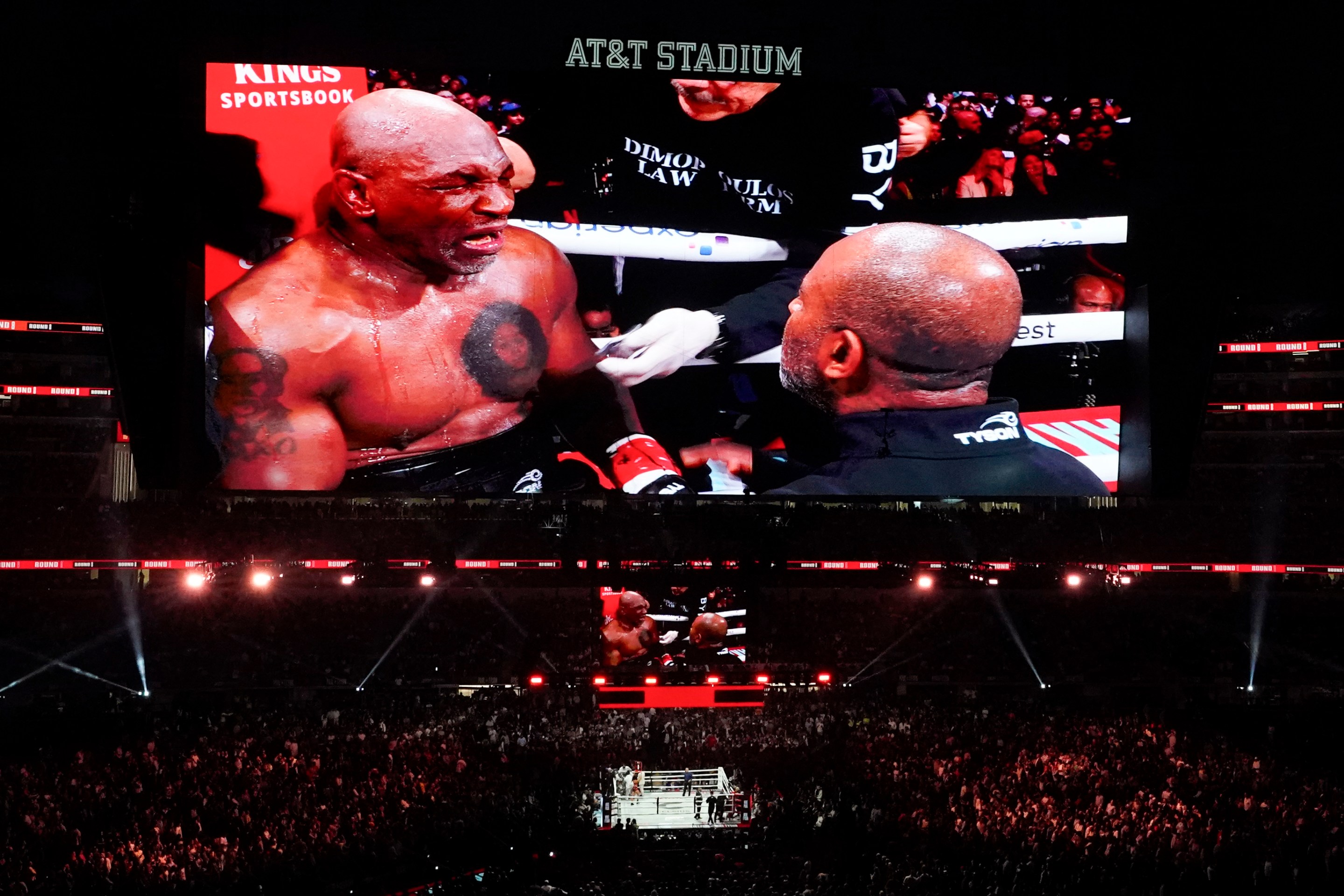 A giant screen above the ring shows US retired pro-boxer Mike Tyson sitting on the corner stool between rounds during the heavyweight boxing bout against Jake Paul on November 15, 2024.