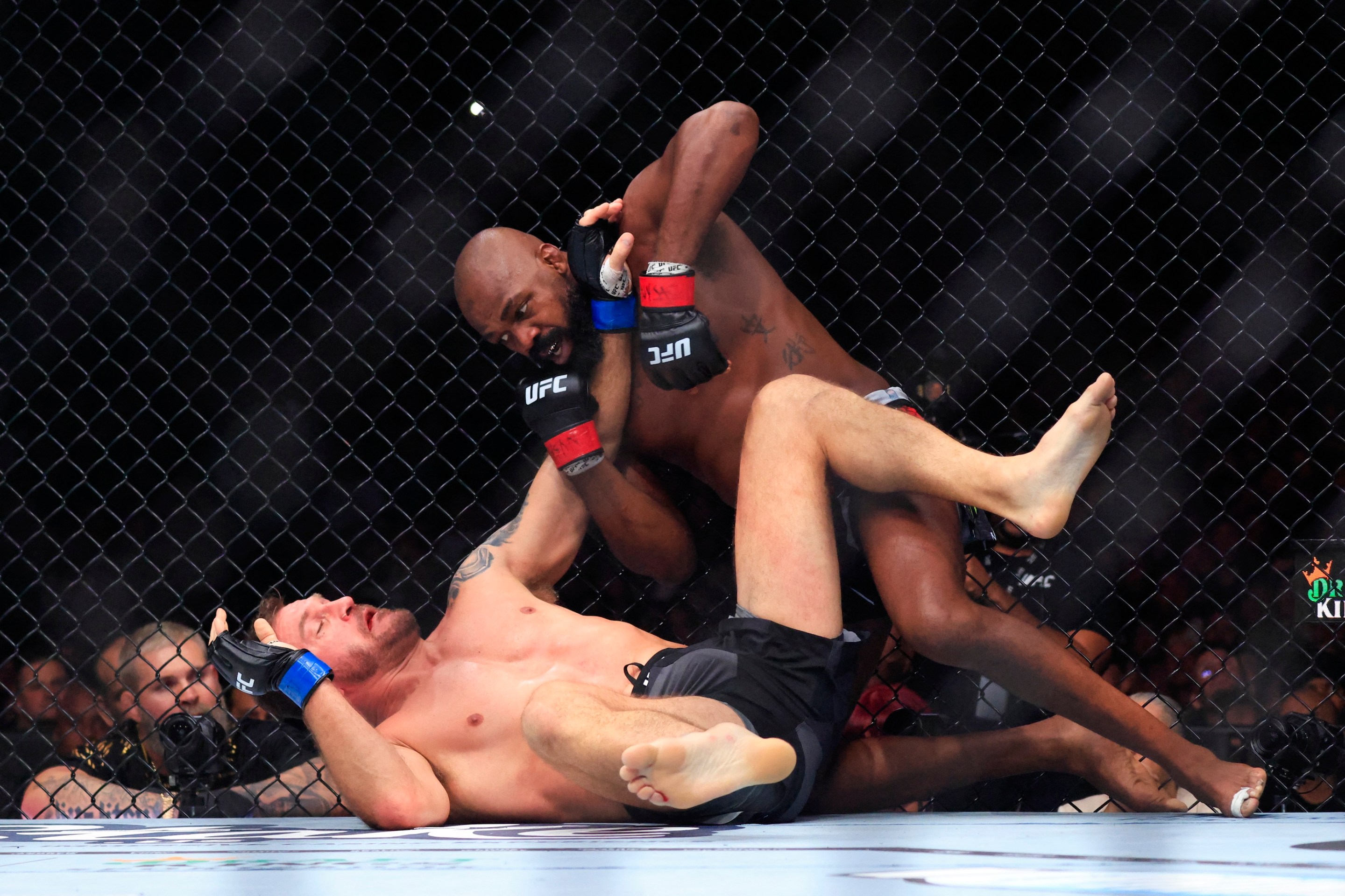 UFC Heavyweight Champion Jon Jones, at right, punches challenger Stipe Miocic, who is on his back, during their heavyweight title bout at Madison Square Garden in New York, on November 16, 2024.