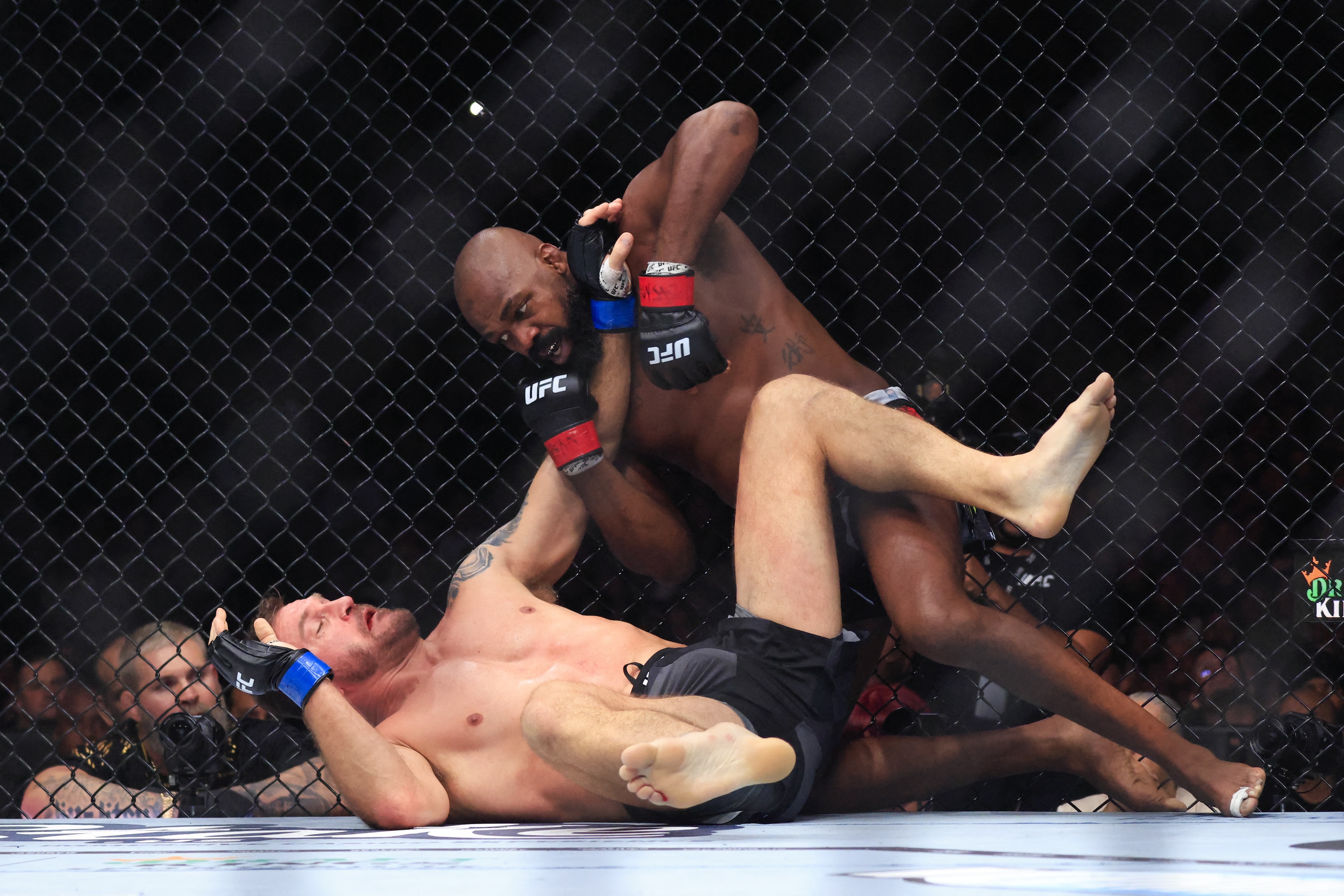 UFC Heavyweight Champion Jon Jones, at right, punches challenger Stipe Miocic, who is on his back, during their heavyweight title bout at Madison Square Garden in New York, on November 16, 2024.