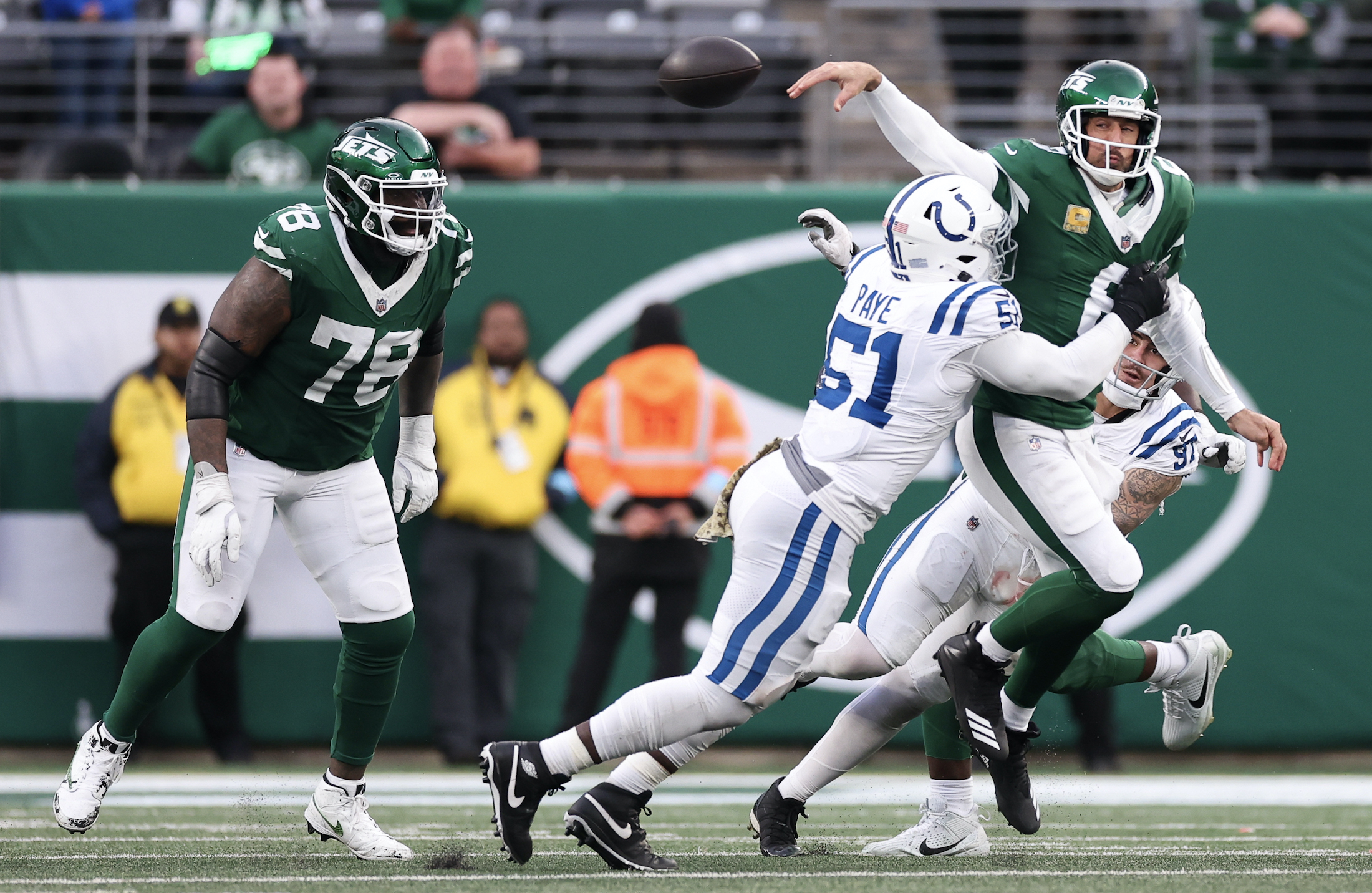 Kwity Paye #51 of the Indianapolis Colts forces a fumble from Aaron Rodgers #8 of the New York Jets during the fourth quarter