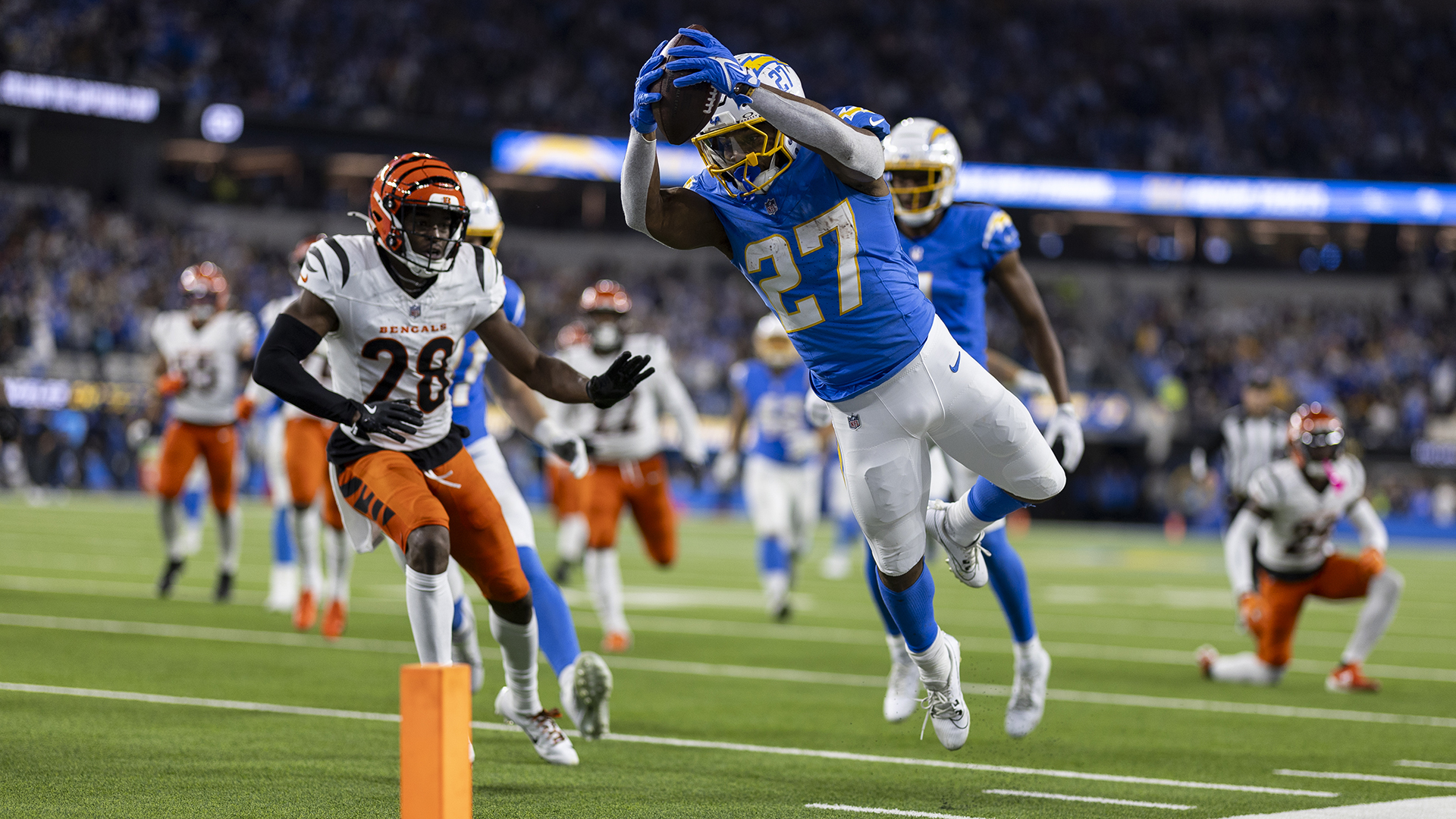 J.K. Dobbins #27 of the Los Angeles Chargers jumps and dives to score a touchdown during an NFL Football game against the Cincinnati Bengals at SoFi Stadium on November 17, 2024 in Inglewood, California.