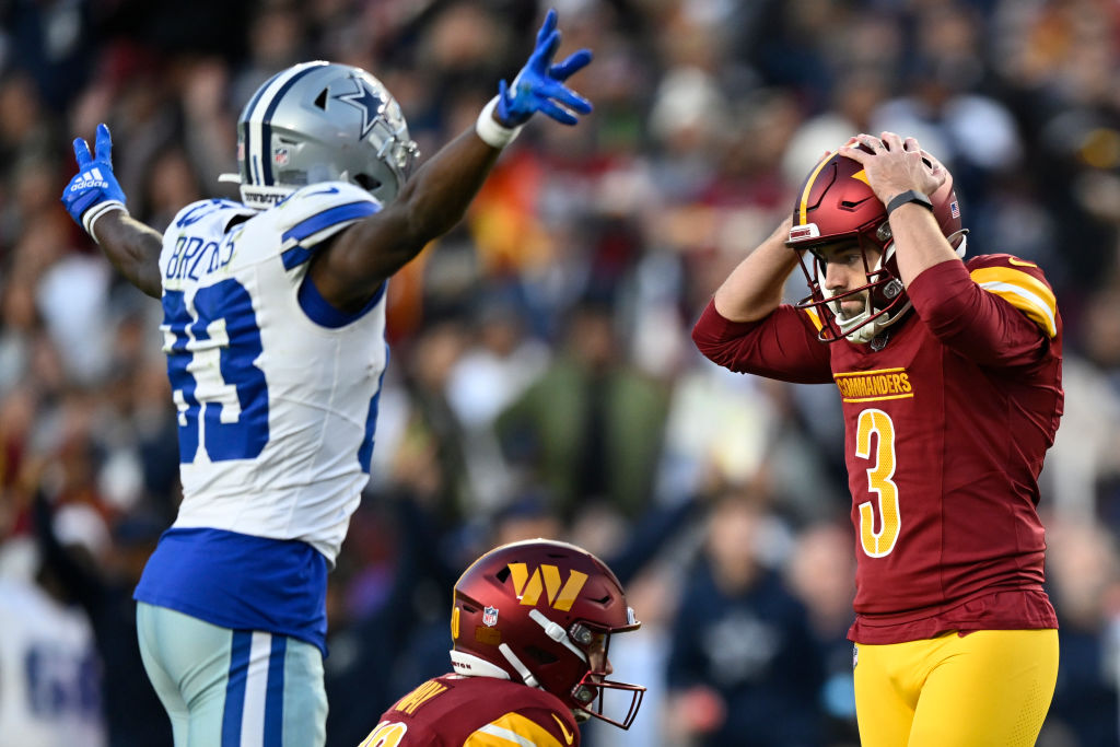 Dallas Cowboys Jalen Brooks, left, celebrates Washington Commanders place kicker Austin Seibert (3) missed extra point