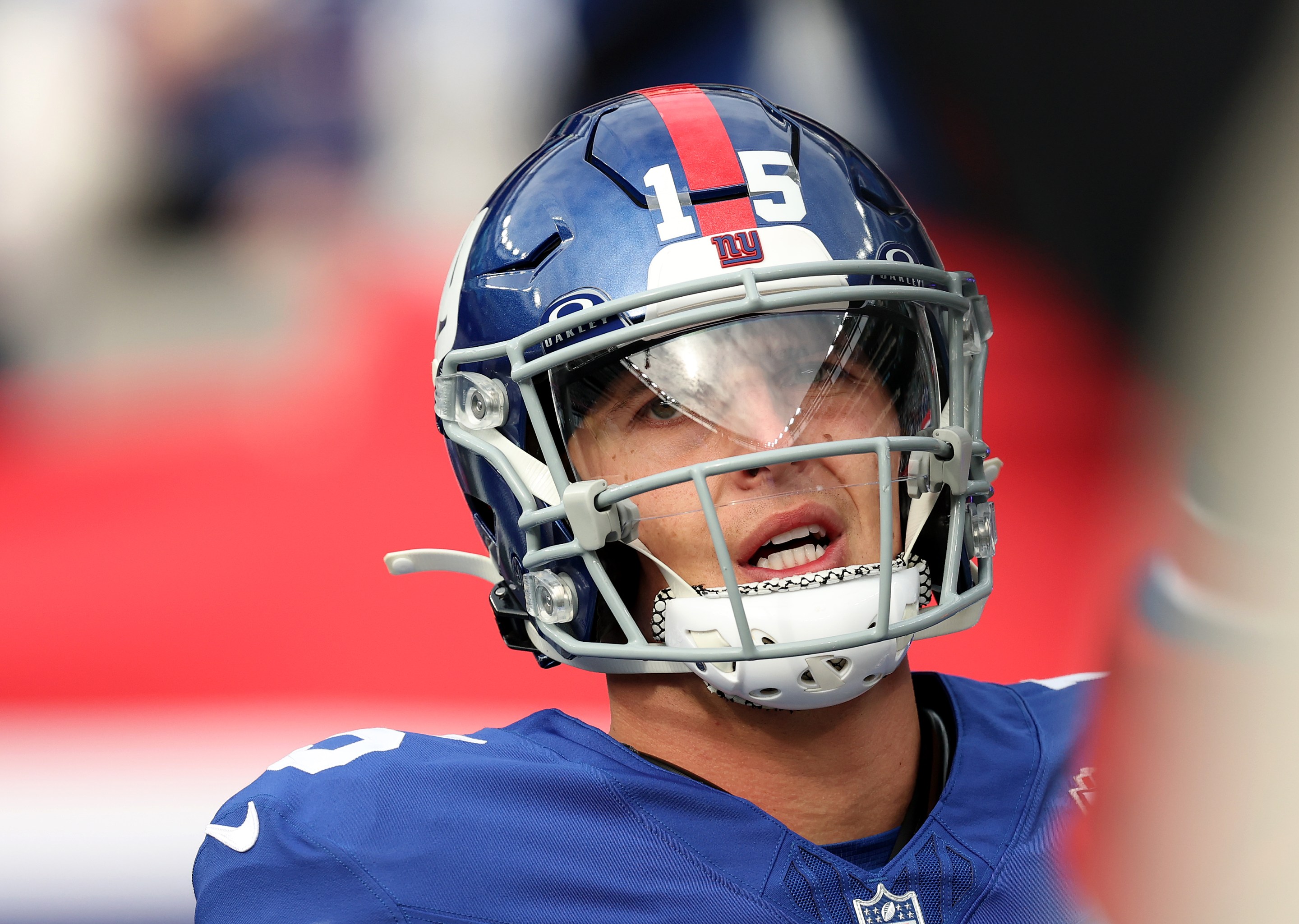 Tommy DeVito of the New York Giants looks pained while warming up before the game against the Tampa Bay Buccaneers at MetLife Stadium on November 24, 2024.