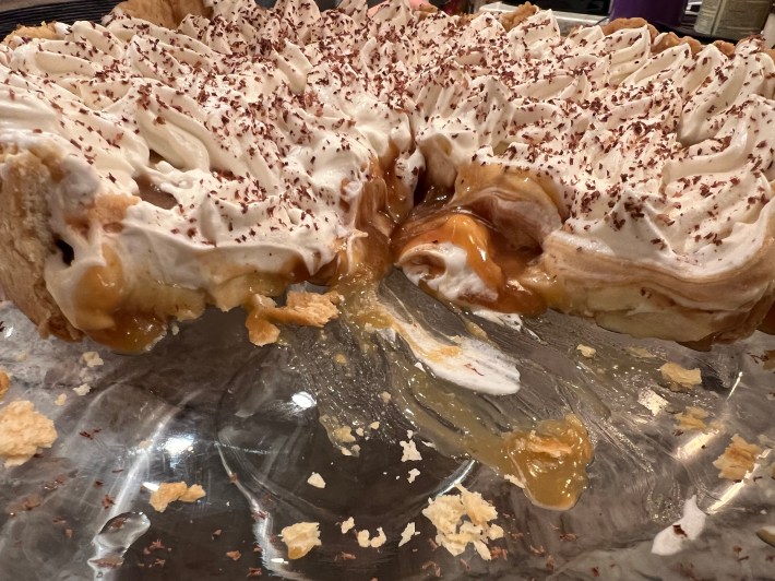 A side view of the interior of a Banoffee Pie, with a wedge removed.