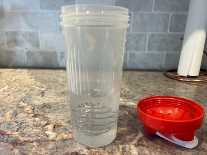 Clear water inside a shaker bottle.