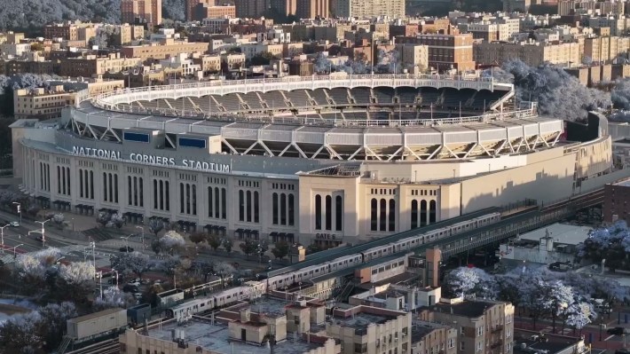 It's an overhead shot of Yankee Stadium, the elevated train going by, with NATIONAL CORNERS STADIUM CGI'd in on the front.