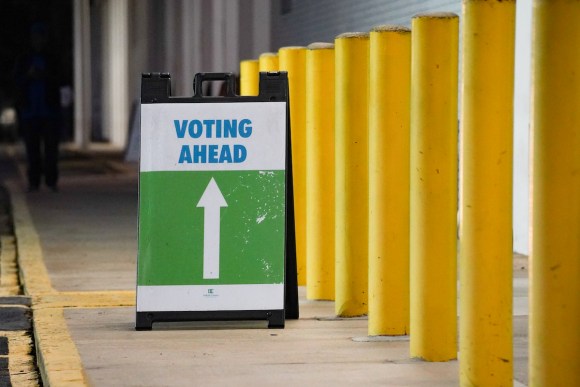 A sign reading VOTING AHEAD at an Atlanta, Ga. early voting location.