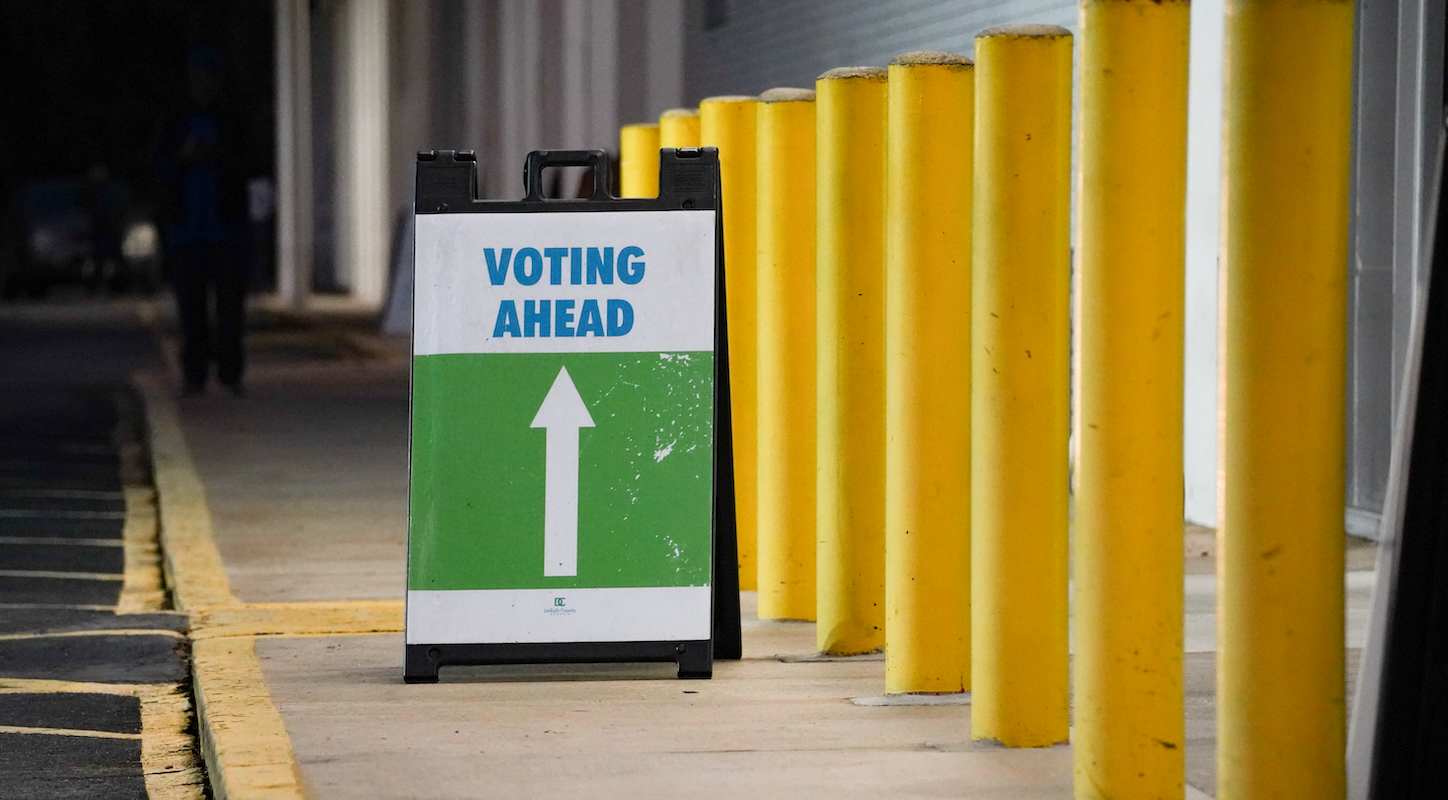 A sign reading VOTING AHEAD at an Atlanta, Ga. early voting location.