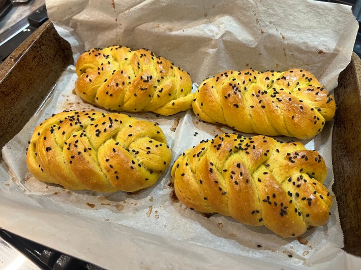 Four fully baked plaited buns.