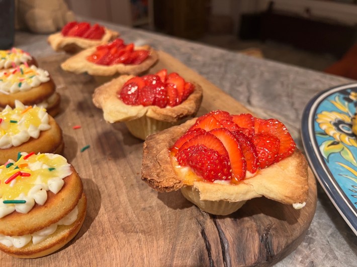 A finished strawberry tart, with a broken crust.