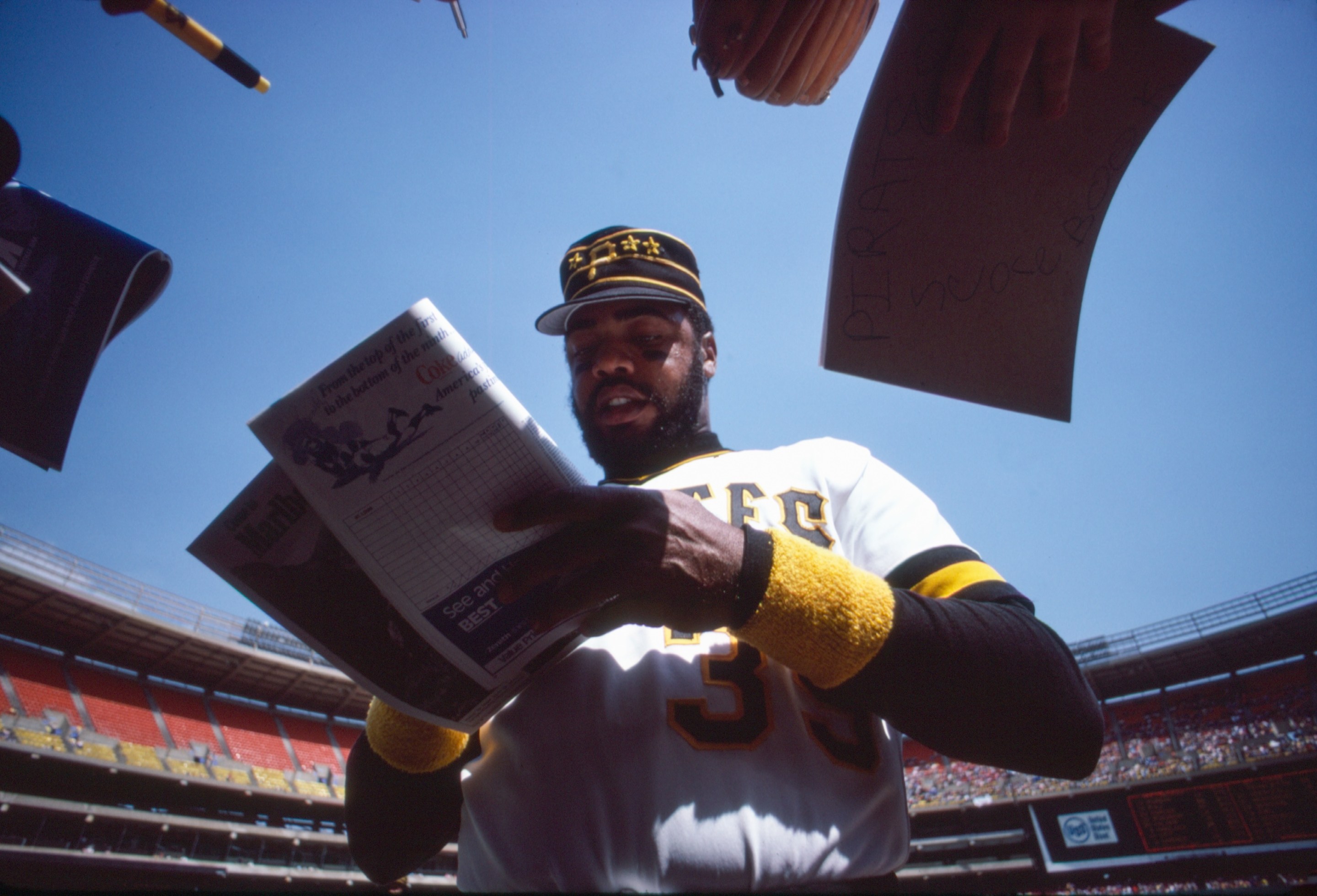 Pittsburgh Pirates right-fielder and All-Star Dave Parker (#39) signs some autographs for fans at a game in April of 1980 at Three Rivers Stadium in Pittsburgh, Pennsylvania.