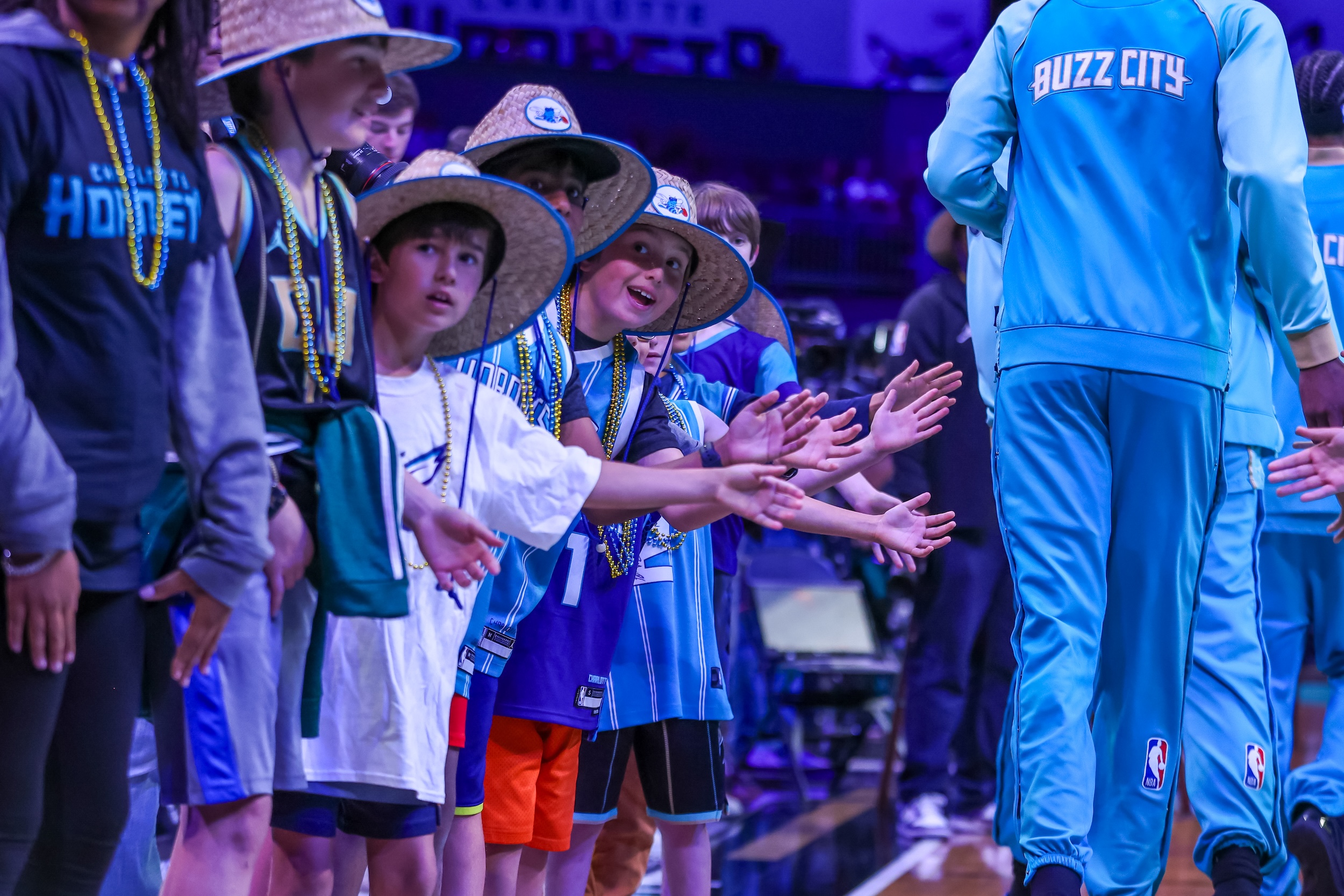 Some kids who are fans of the Charlotte Hornets.