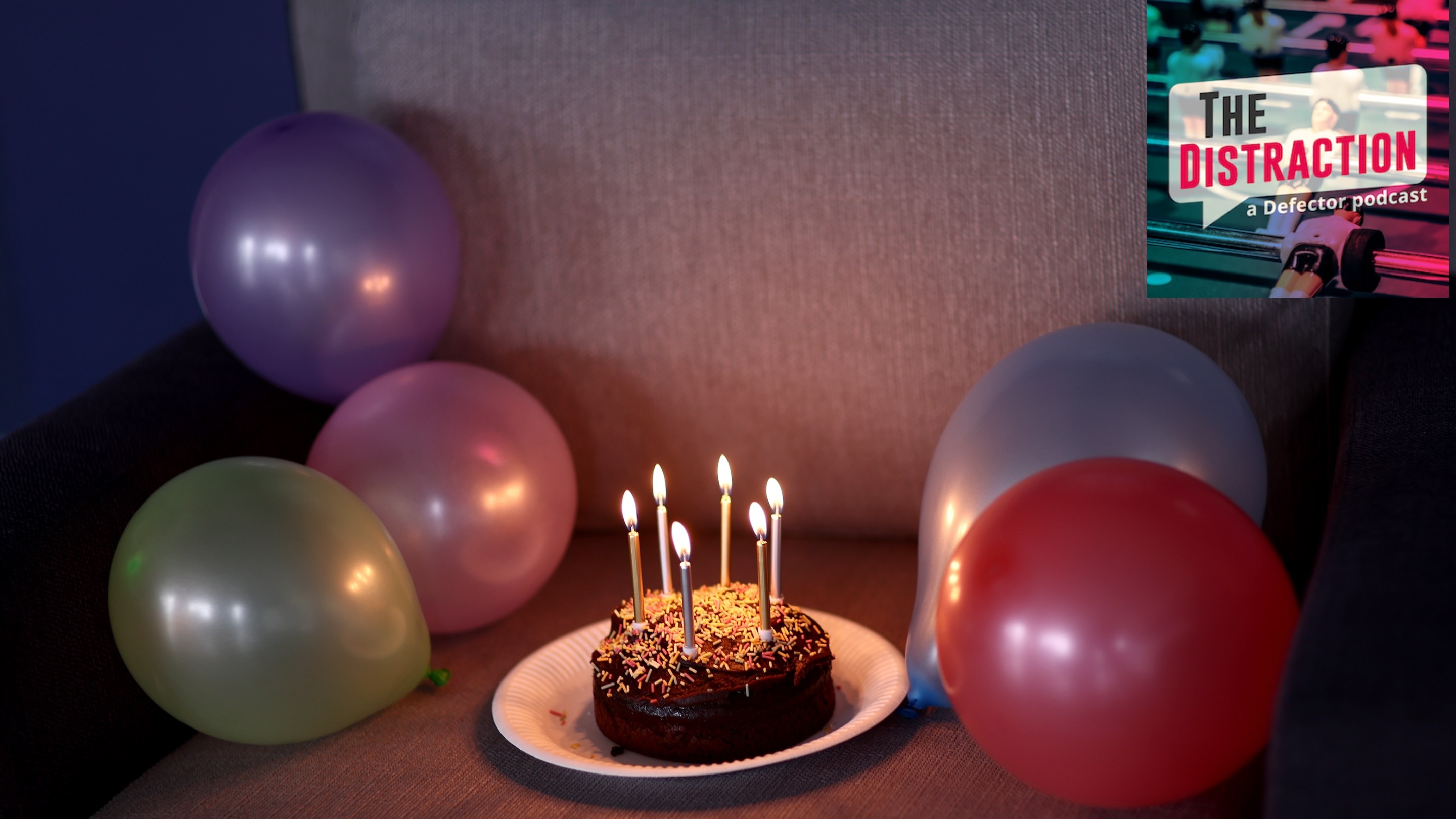 A birthday cake is seen for Jess Park of England (not pictured) at St George's Park Futsal Arena on October 21, 2024 in Burton upon Trent, England. It's kind of a saddish cake sitting on what looks like a couch. The Distraction logo is at upper right.