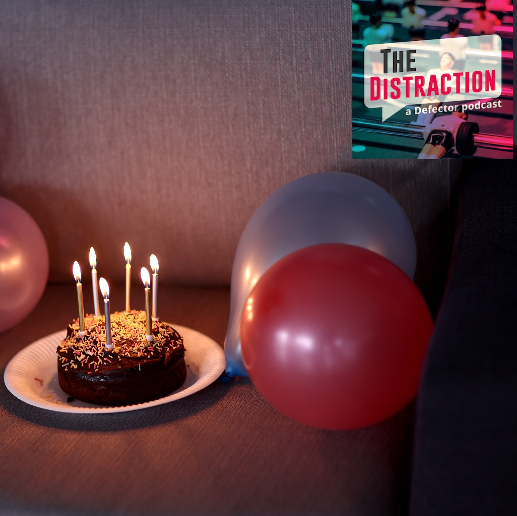 A birthday cake is seen for Jess Park of England (not pictured) at St George's Park Futsal Arena on October 21, 2024 in Burton upon Trent, England. It's kind of a saddish cake sitting on what looks like a couch. The Distraction logo is at upper right.