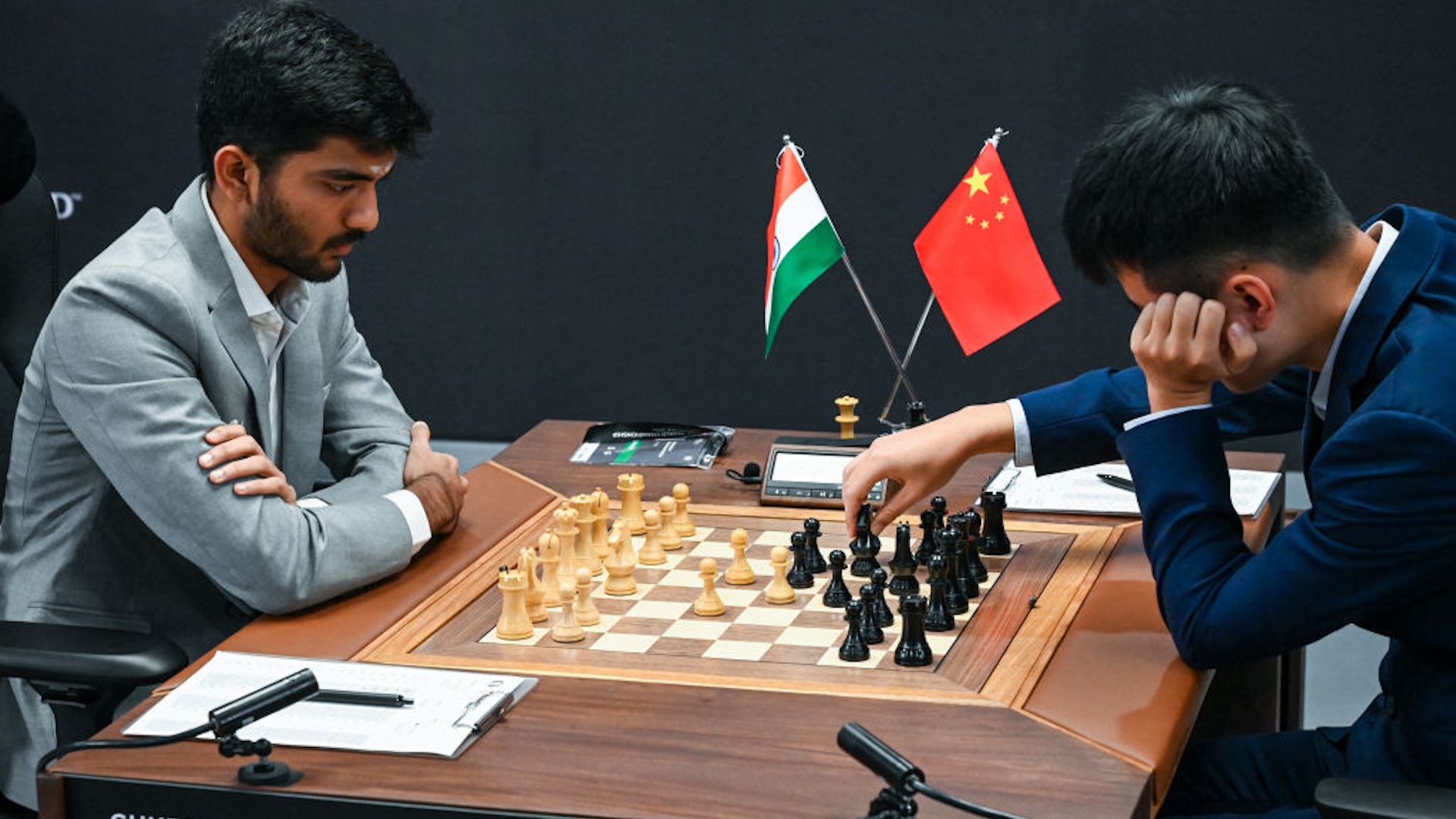 China’s chess grandmaster Ding Liren (R) and India’s chess grandmaster Gukesh Dommaraju (L) compete during the start of the FIDE World Chess Championship in Singapore on November 25, 2024.