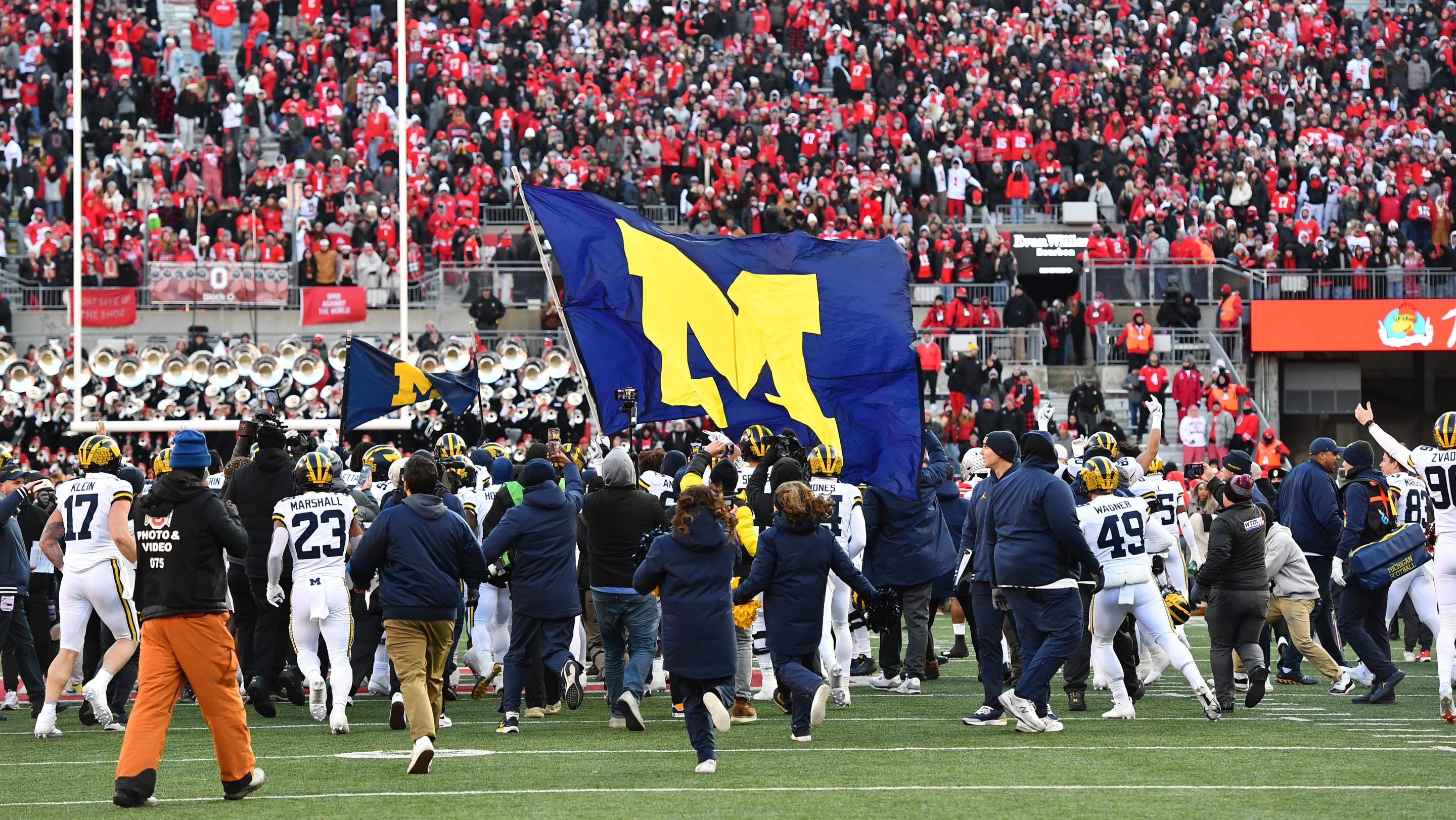 Michigan Wolverines players fly a flag prior to a brawl between players from both teams following a 13-10 Michigan win against the Ohio State Buckeyes at Ohio Stadium on November 30, 2024 in Columbus, Ohio.