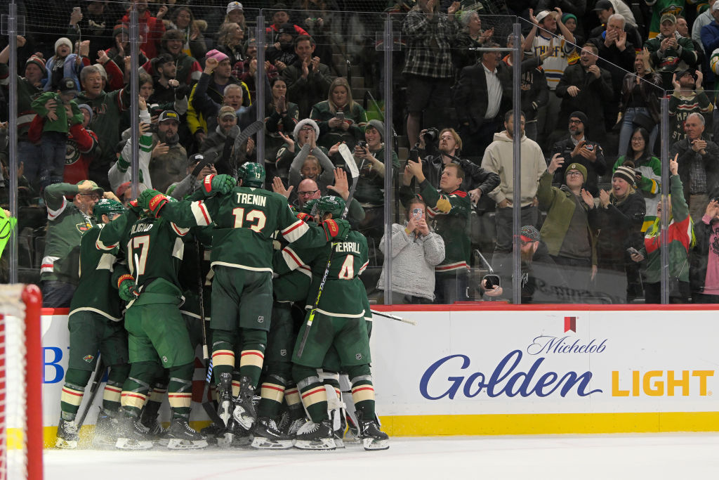 Minnesota Wild forward Kirill Kaprizov (97) is mauled by teammates after scoring an overtime game-winning goal