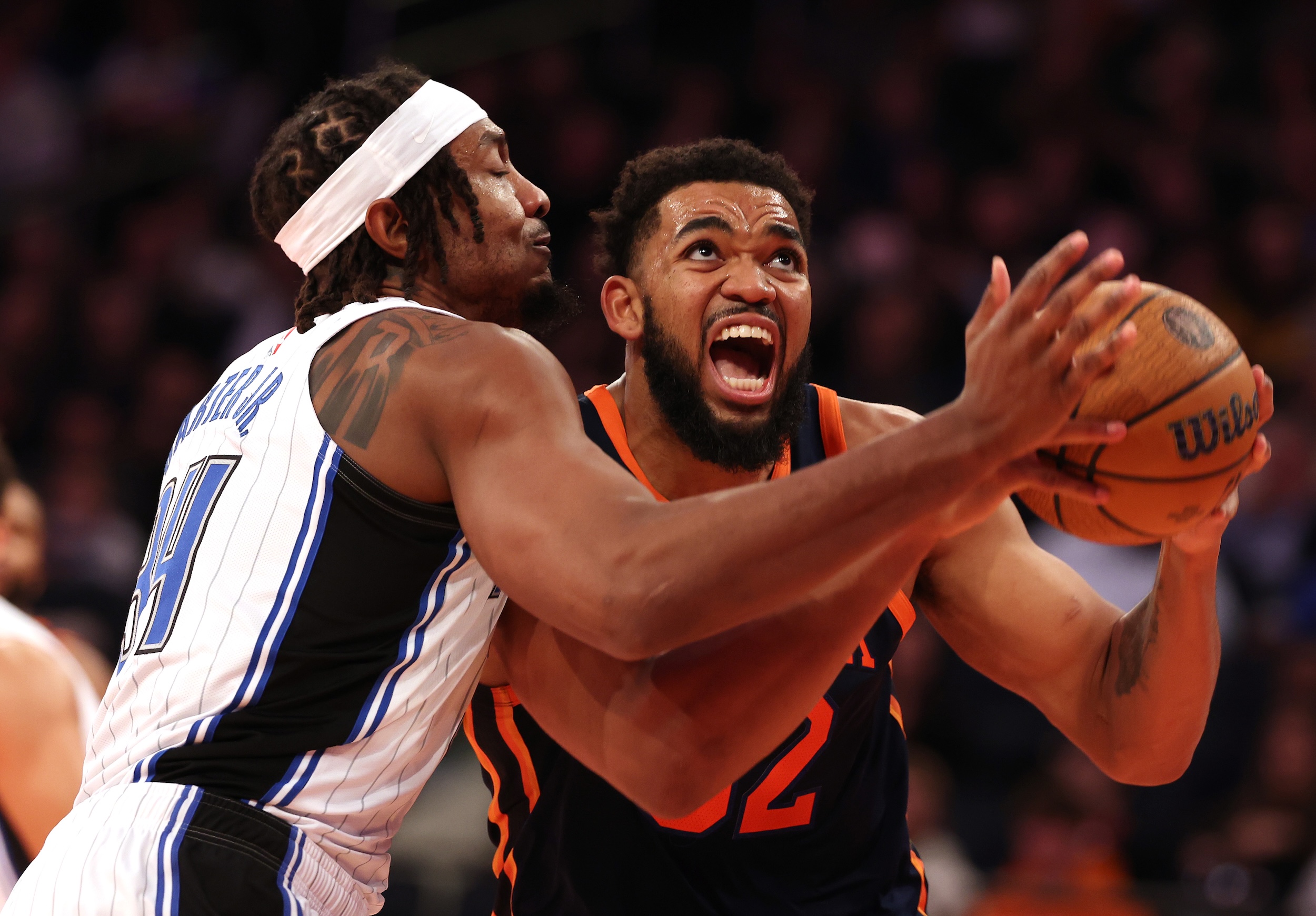 Karl-Anthony Towns drives to the cup against Wendell Carter Jr. of the Magic.