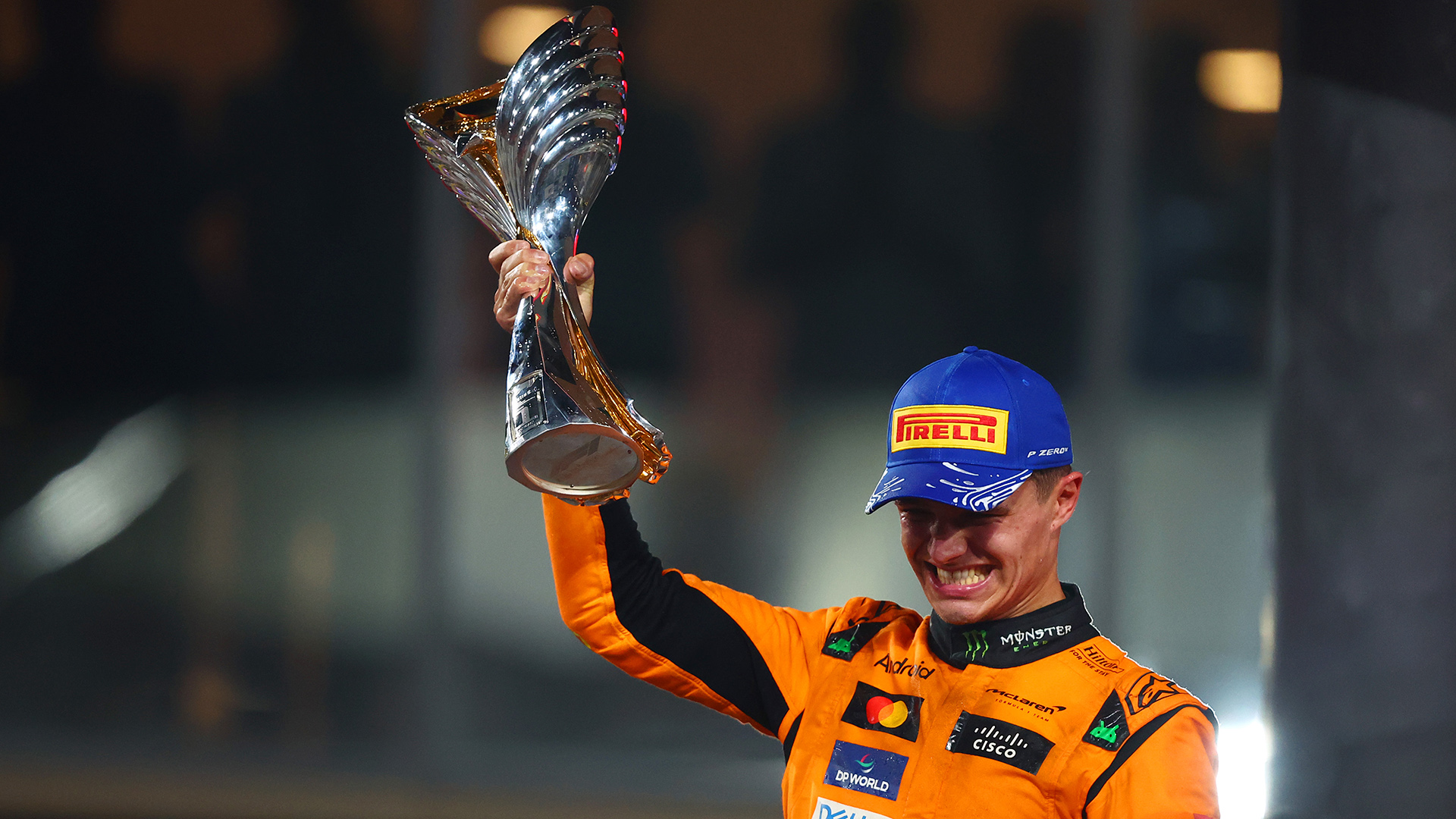 Race winner Lando Norris of Great Britain and McLaren celebrates on the podium during the F1 Grand Prix of Abu Dhabi at Yas Marina Circuit on December 08, 2024 in Abu Dhabi, United Arab Emirates.