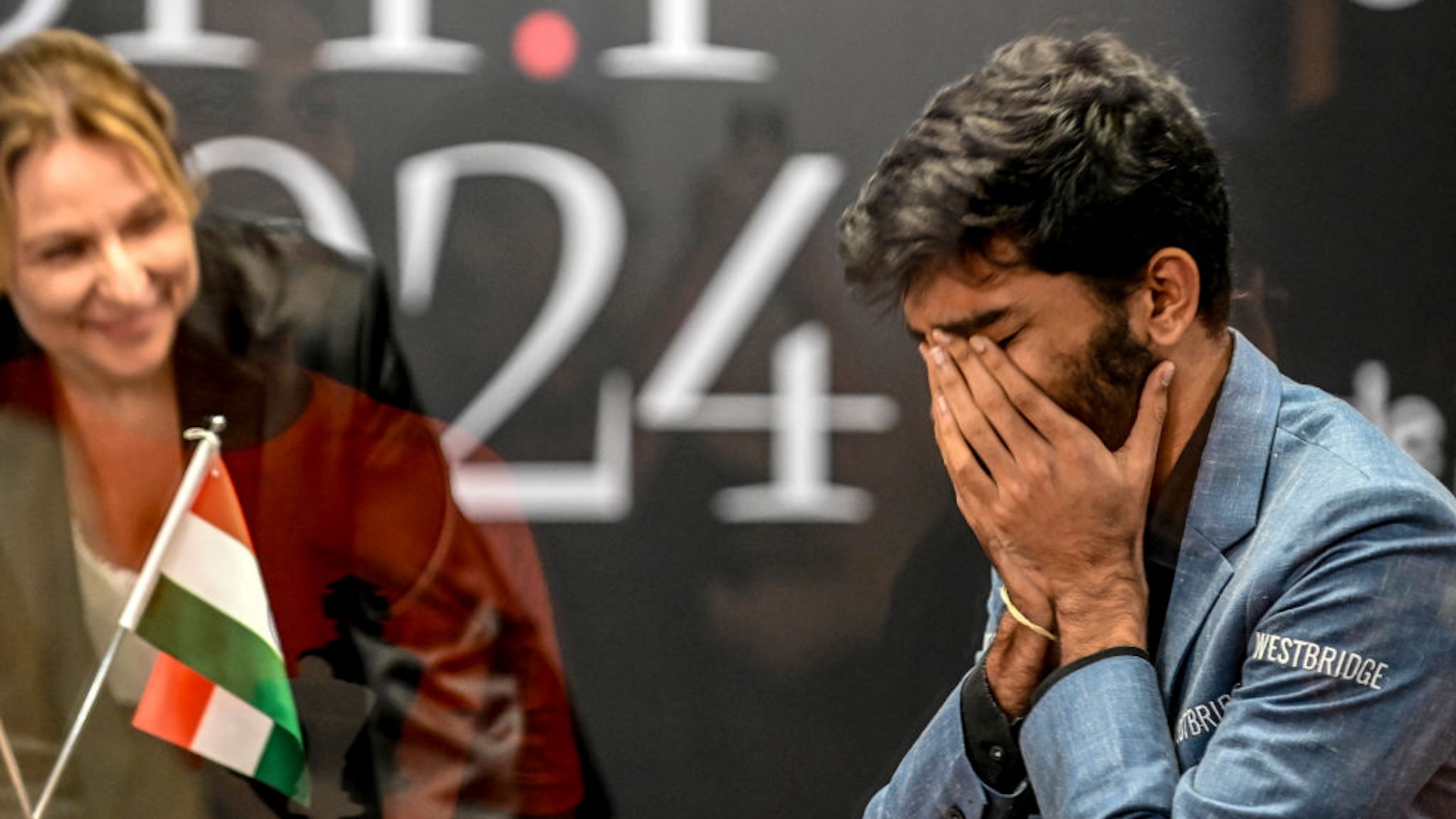 India's grandmaster Gukesh Dommaraju (R) reacts after winning against China's chess grandmaster Ding Liren in game 14 of the 2024 FIDE World Championship in Singapore on December 12, 2024. The 18-year-old became "the YOUNGEST WORLD CHAMPION in history", said the International Chess Federation in a post on social media platform X, after Ding resigned in a thrilling endgame that had been expected to end in a draw.