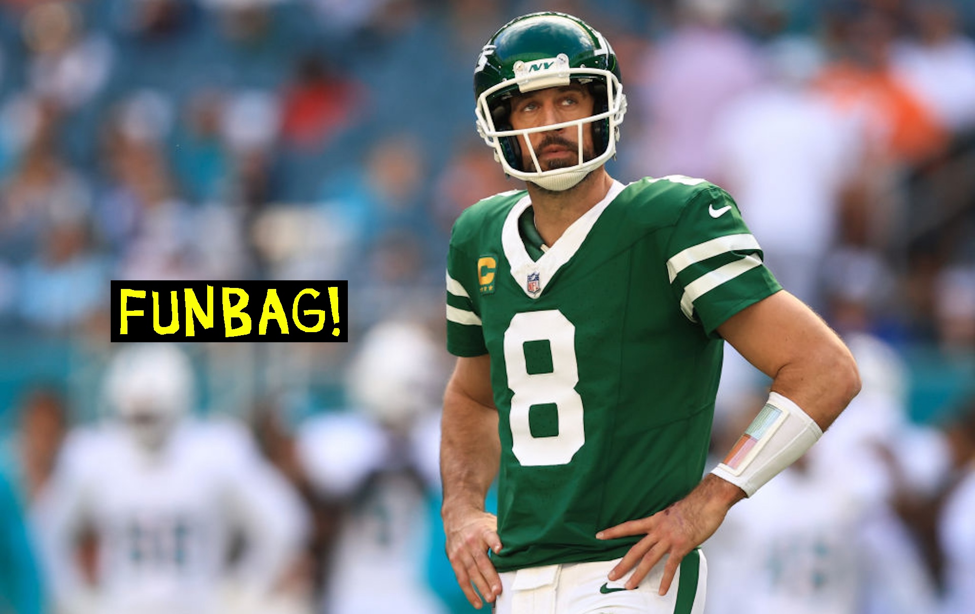 MIAMI GARDENS, FLORIDA - DECEMBER 08: Aaron Rodgers #8 of the New York Jets reacts on the field during the first half of the game against the Miami Dolphins at Hard Rock Stadium on December 08, 2024 in Miami Gardens, Florida.