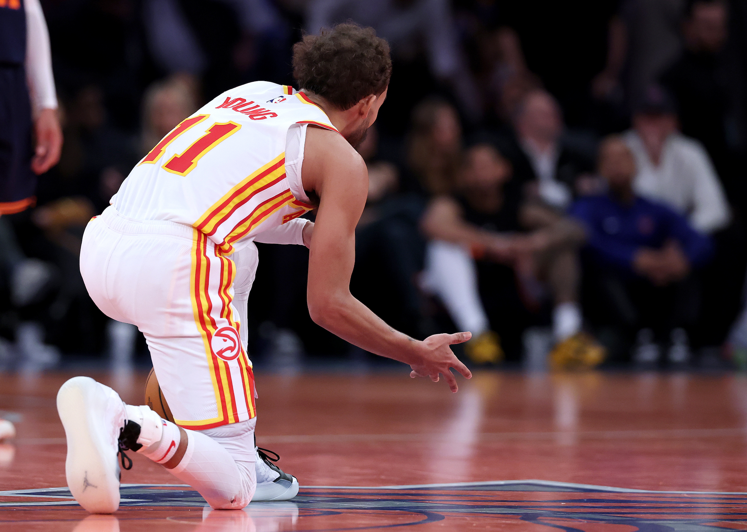 Trae Young #11 of the Atlanta Hawks celebrates the win on the logo after the quarterfinal game of the Emirates NBA Cup against the New York Knicks at Madison Square Garden on December 11, 2024 in New York City. The Atlanta Hawks defeated the New York Knicks 108-100 to advance to the semifinal round. NOTE TO USER: User expressly acknowledges and agrees that, by downloading and or using this photograph, User is consenting to the terms and conditions of the Getty Images License Agreement. (Photo by Elsa/Getty Images)