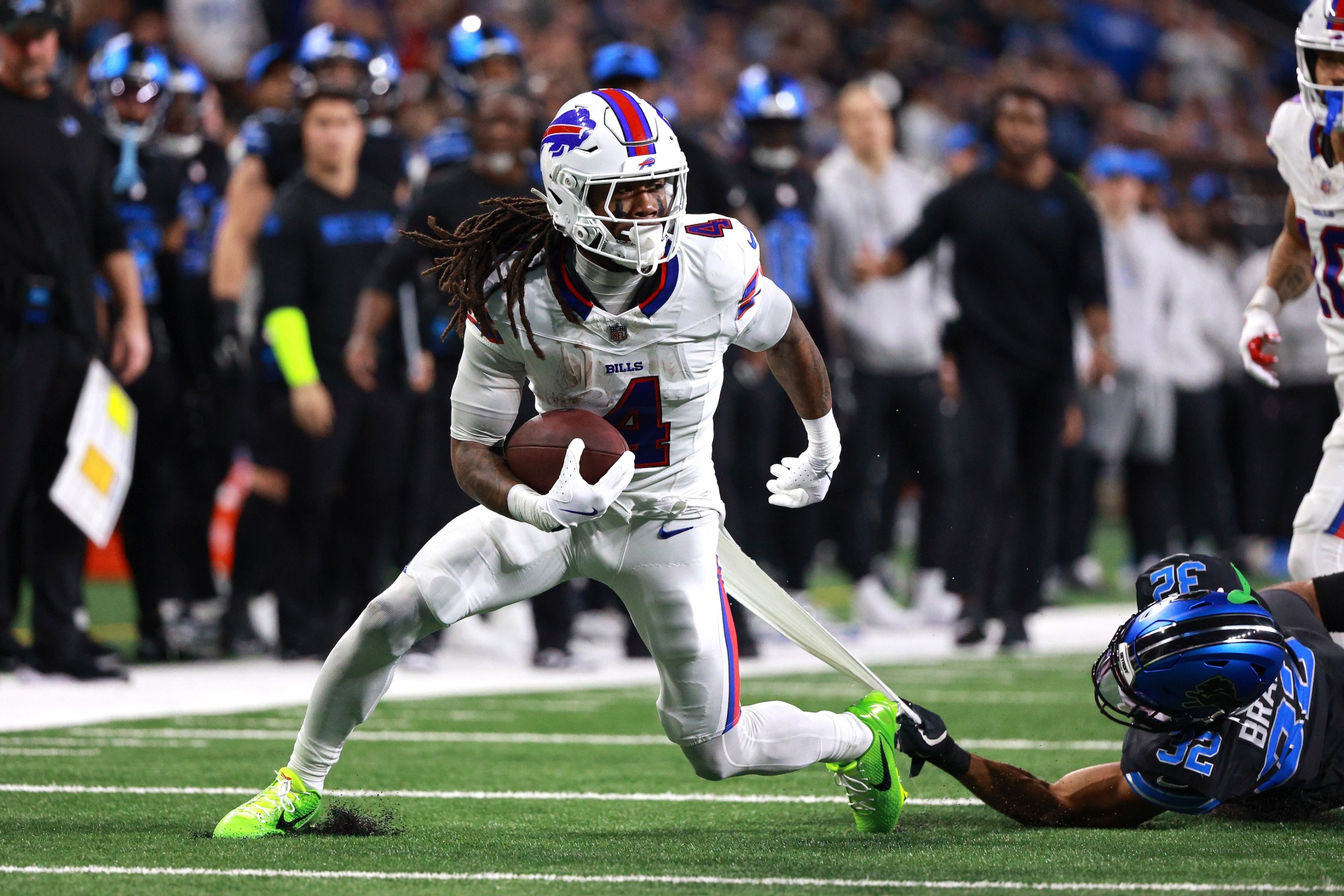 Buffalo Bills running back James Cook #4 runs the ball during the first half of an NFL football game between the Buffalo Bills and the Detroit Lions at Ford Field in Detroit, Michigan.