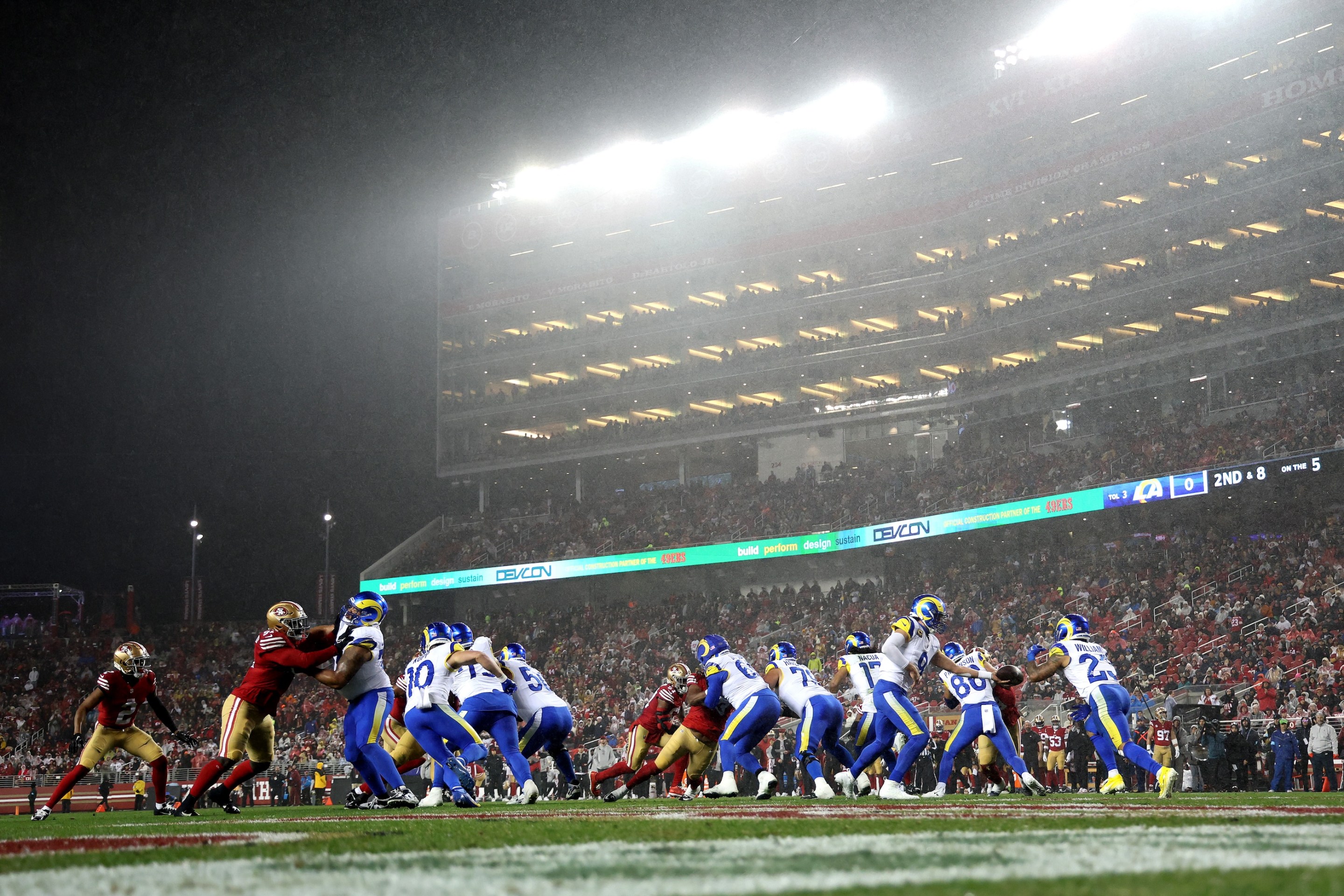 Matthew Stafford hands the ball to Kyren Williams against the San Francisco 49ers during the second quarter in the game at Levi's Stadium on December 12, 2024 in Santa Clara, California. It is a low-angle shot and raining as hell.