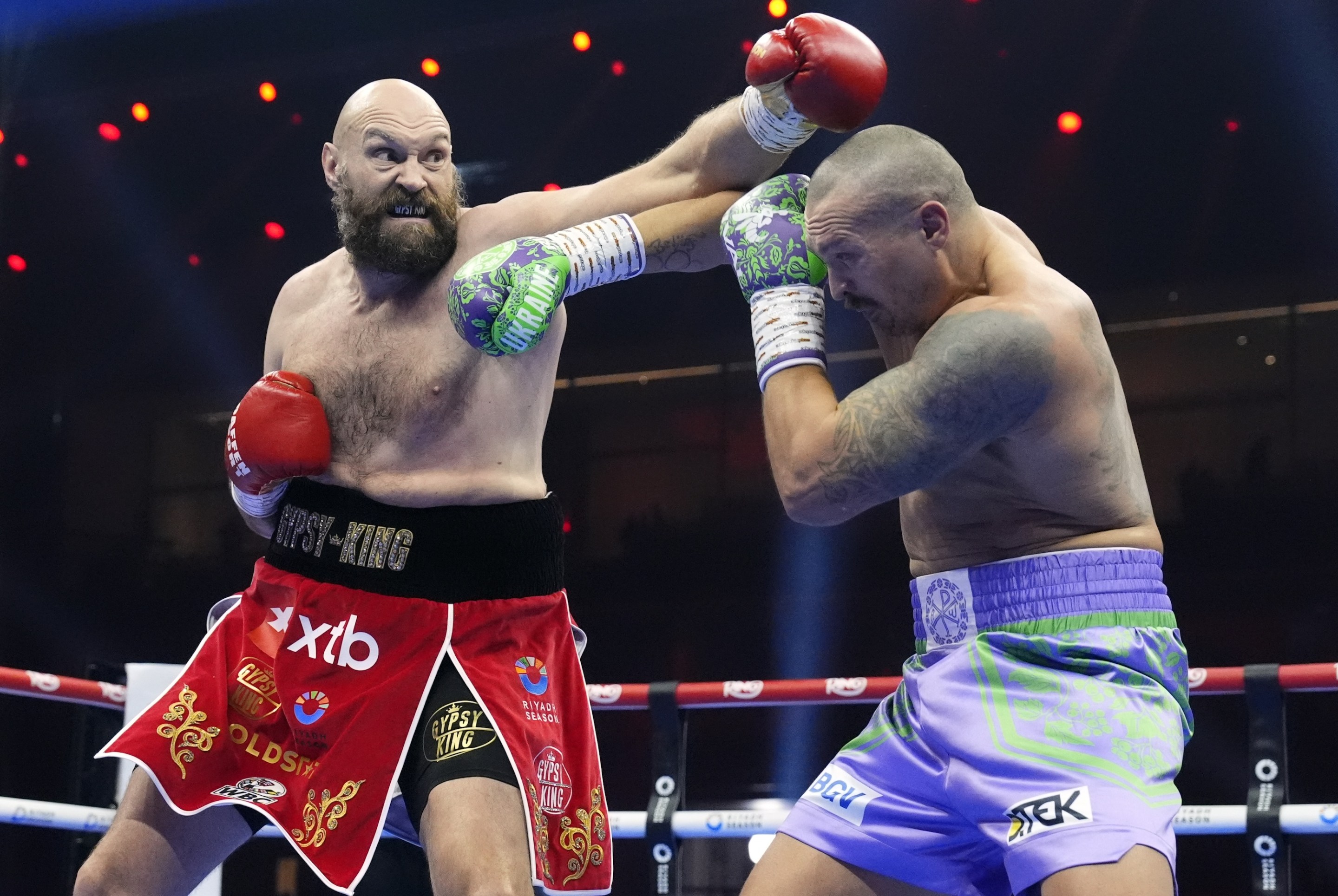 Tyson Fury (left) and Oleksandr Usyk during the WBA, WBC, WBO, IBO World Heavyweight championship contest at the Kingdom Arena in Riyadh, Saudi Arabia. Picture date: Saturday December 21, 2024. (Photo by Nick Potts/PA Images via Getty Images)