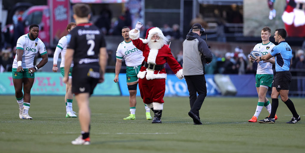 BARNET, ENGLAND - DECEMBER 22: Santa Claus, who delivered the match ball waves to the crowd during the Gallagher Premiership Rugby match between Saracens and Northampton Saints at the StoneX Stadium on December 22, 2024 in Barnet, England.