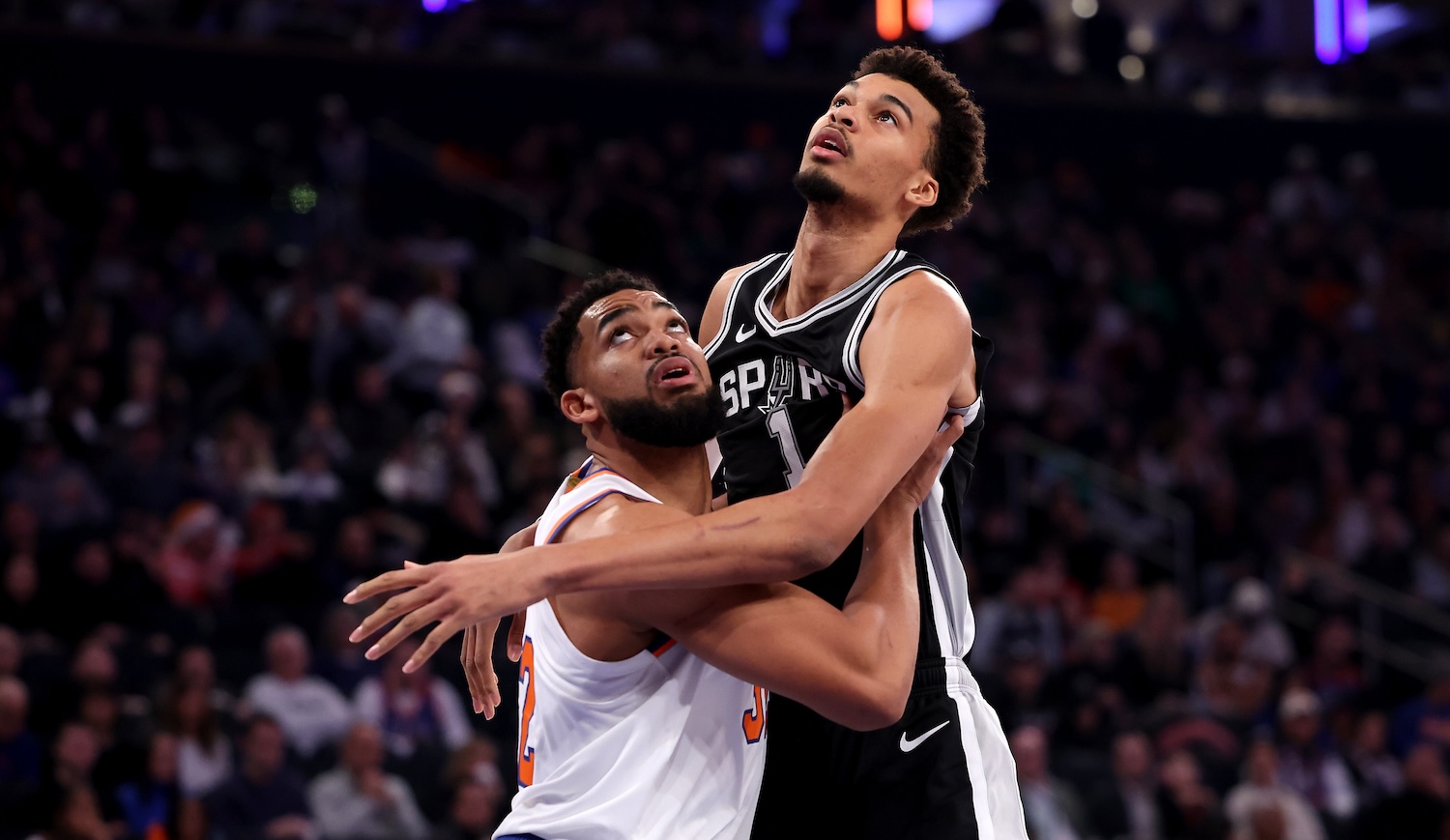 NEW YORK, NEW YORK - DECEMBER 25: Karl-Anthony Towns #32 of the New York Knicks and Victor Wembanyama #1 of the San Antonio Spurs battle for a rebound during the first quarter at Madison Square Garden on December 25, 2024 in New York City. NOTE TO USER: User expressly acknowledges and agrees that, by downloading and or using this photograph, User is consenting to the terms and conditions of the Getty Images License Agreement. (Photo by Luke Hales/Getty Images)