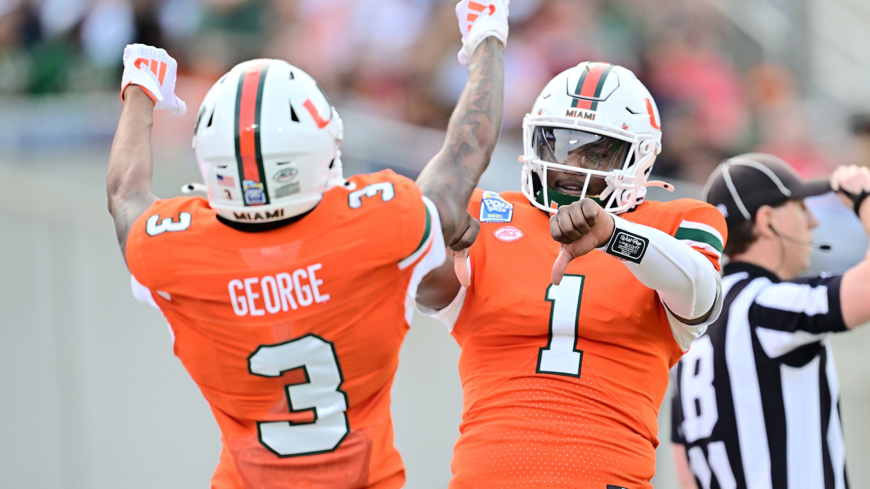 Cam Ward #1 of the Miami Hurricanes celebrates with Jacolby George #3 after connecting for a touchdown in the first quarter during the 2024 Pop-Tarts Bowl