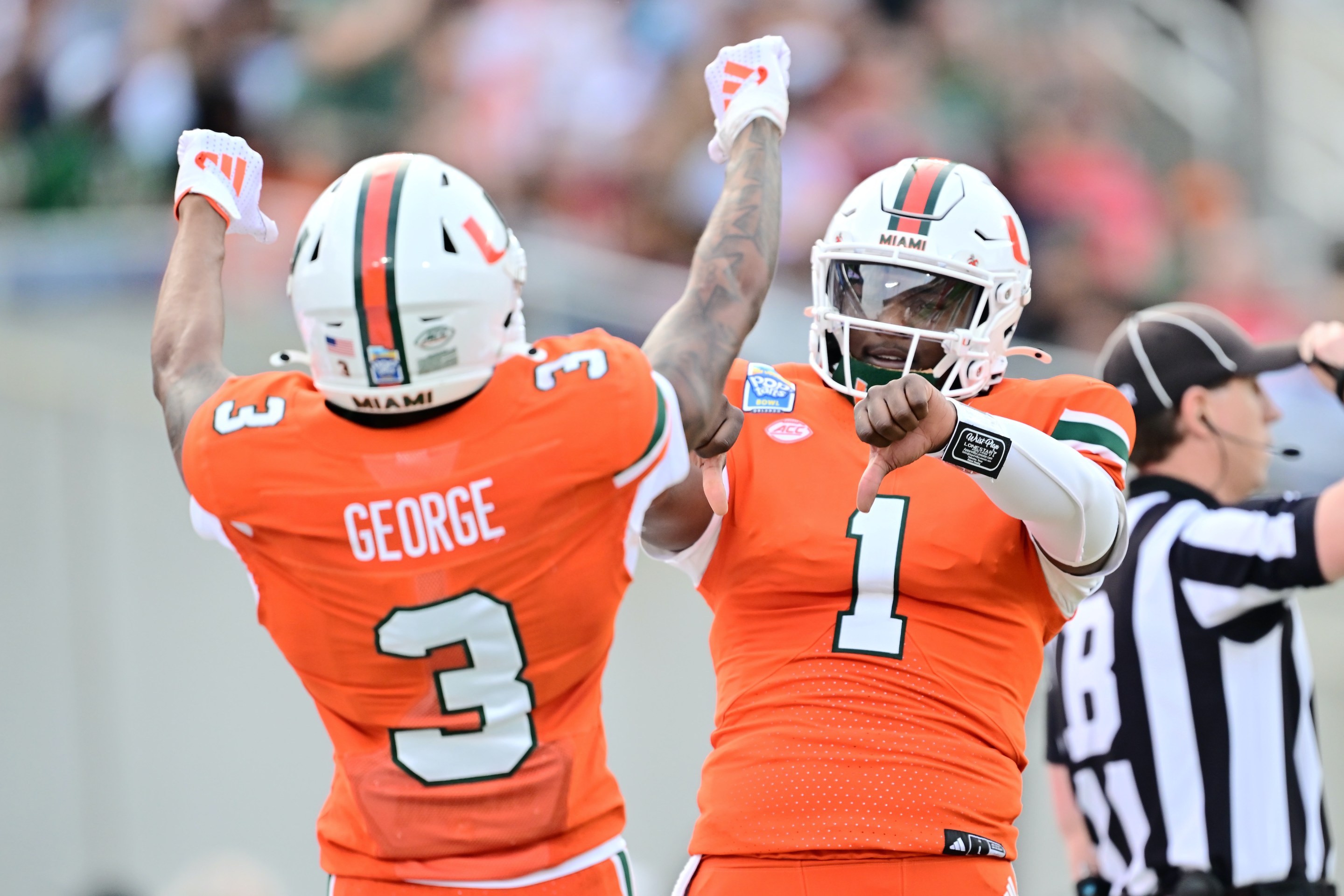 Cam Ward #1 of the Miami Hurricanes celebrates with Jacolby George #3 after connecting for a touchdown in the first quarter during the 2024 Pop-Tarts Bowl