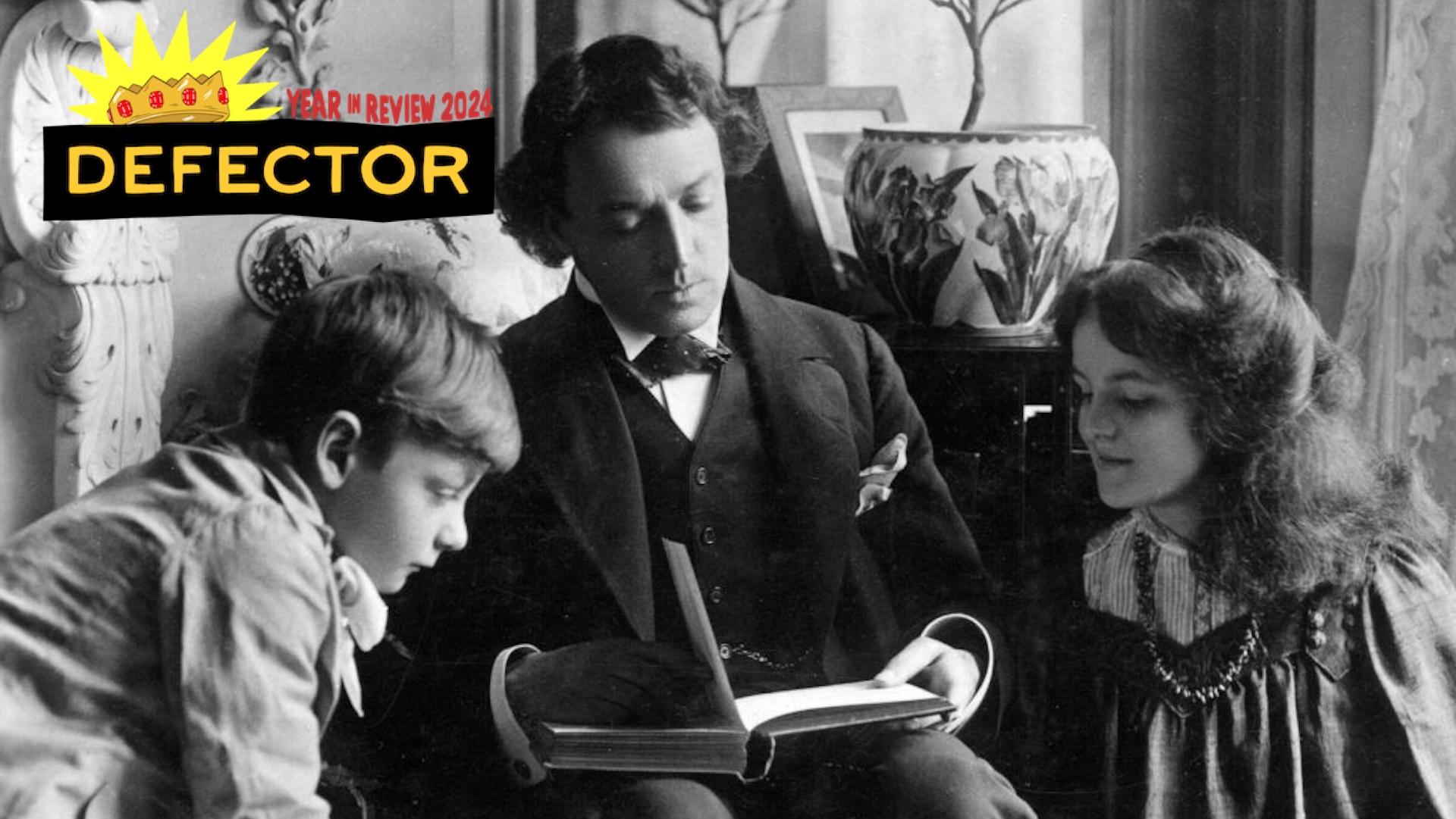 circa 1897: Portrait of actor John Martin Harvey (1867 - 1944) reading to two children on a postcard.