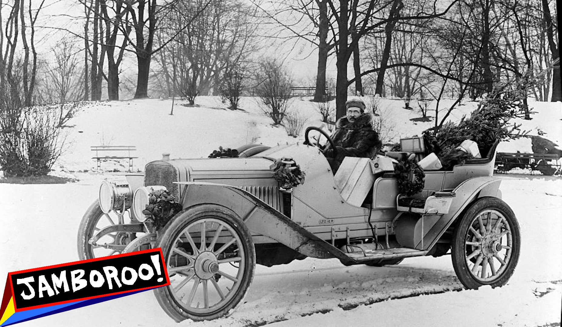 Automobile in a winter landscape with a man coming from Christmas shopping trip with packages, Christmas Tree, etc. Undated photograph circa 1911.