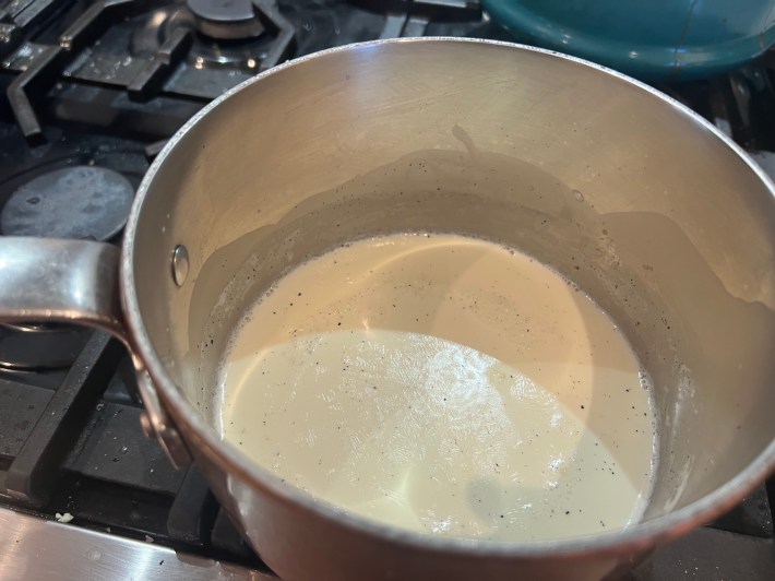 Milk and cream warming in a small saucepan.