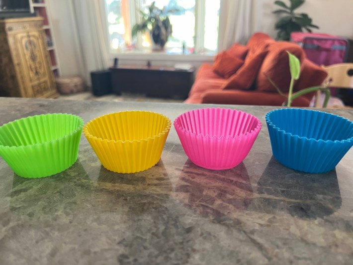 Four silicone muffin cups sit on a countertop.