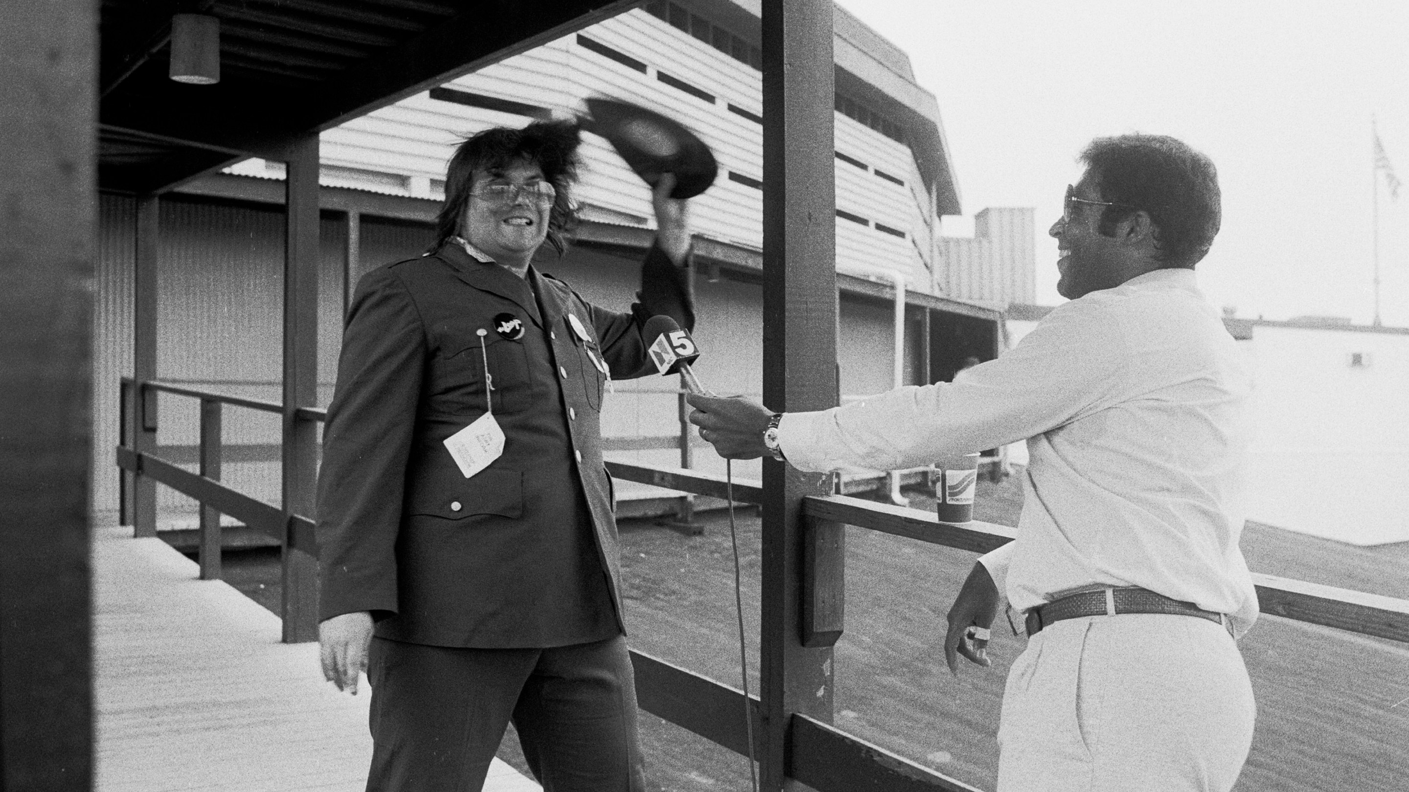 During an interview with sportscaster Greg Gumbel (right), American disc jockey (from WLUP radio, 'The Loop') Steve Dahl breaks a disco record over his head prior to hosting an anti-disco promotion at Comiskey Park, Chicago, Illinois, July 12, 1979. The event, held between games of a doubleheader between the Chicago White Sox and the Detroit Tigers, allowed fans to attend the games for 98 cents along with an unwanted record and, following the detonation of those records, eventually resulted in the White Sox forfeiture of the second game due to unsafe playing conditions when fans stormed the field causing serious damage to the venue and playing surface.