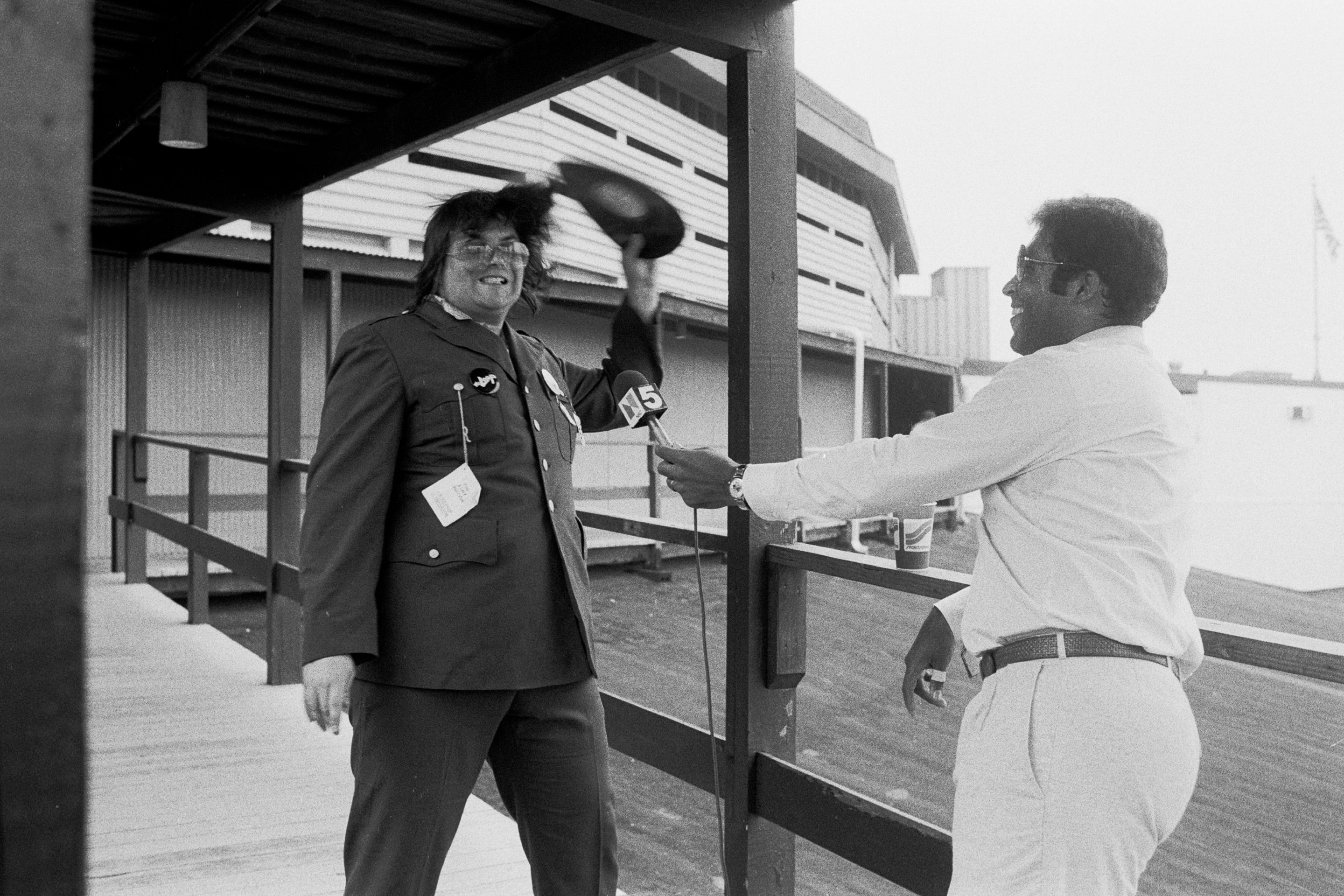 During an interview with sportscaster Greg Gumbel (right), American disc jockey (from WLUP radio, 'The Loop') Steve Dahl breaks a disco record over his head prior to hosting an anti-disco promotion at Comiskey Park, Chicago, Illinois, July 12, 1979. The event, held between games of a doubleheader between the Chicago White Sox and the Detroit Tigers, allowed fans to attend the games for 98 cents along with an unwanted record and, following the detonation of those records, eventually resulted in the White Sox forfeiture of the second game due to unsafe playing conditions when fans stormed the field causing serious damage to the venue and playing surface.