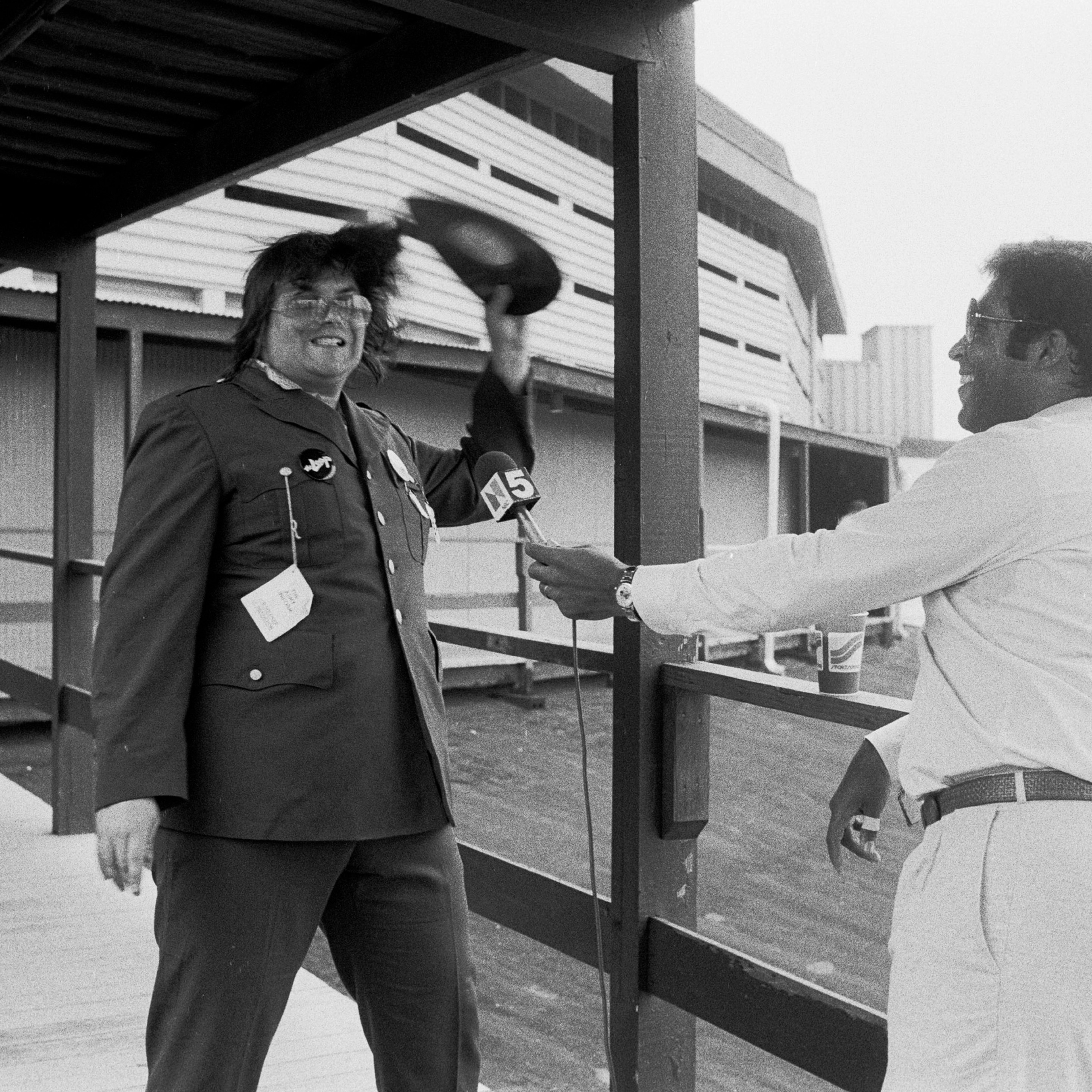 During an interview with sportscaster Greg Gumbel (right), American disc jockey (from WLUP radio, 'The Loop') Steve Dahl breaks a disco record over his head prior to hosting an anti-disco promotion at Comiskey Park, Chicago, Illinois, July 12, 1979. The event, held between games of a doubleheader between the Chicago White Sox and the Detroit Tigers, allowed fans to attend the games for 98 cents along with an unwanted record and, following the detonation of those records, eventually resulted in the White Sox forfeiture of the second game due to unsafe playing conditions when fans stormed the field causing serious damage to the venue and playing surface.