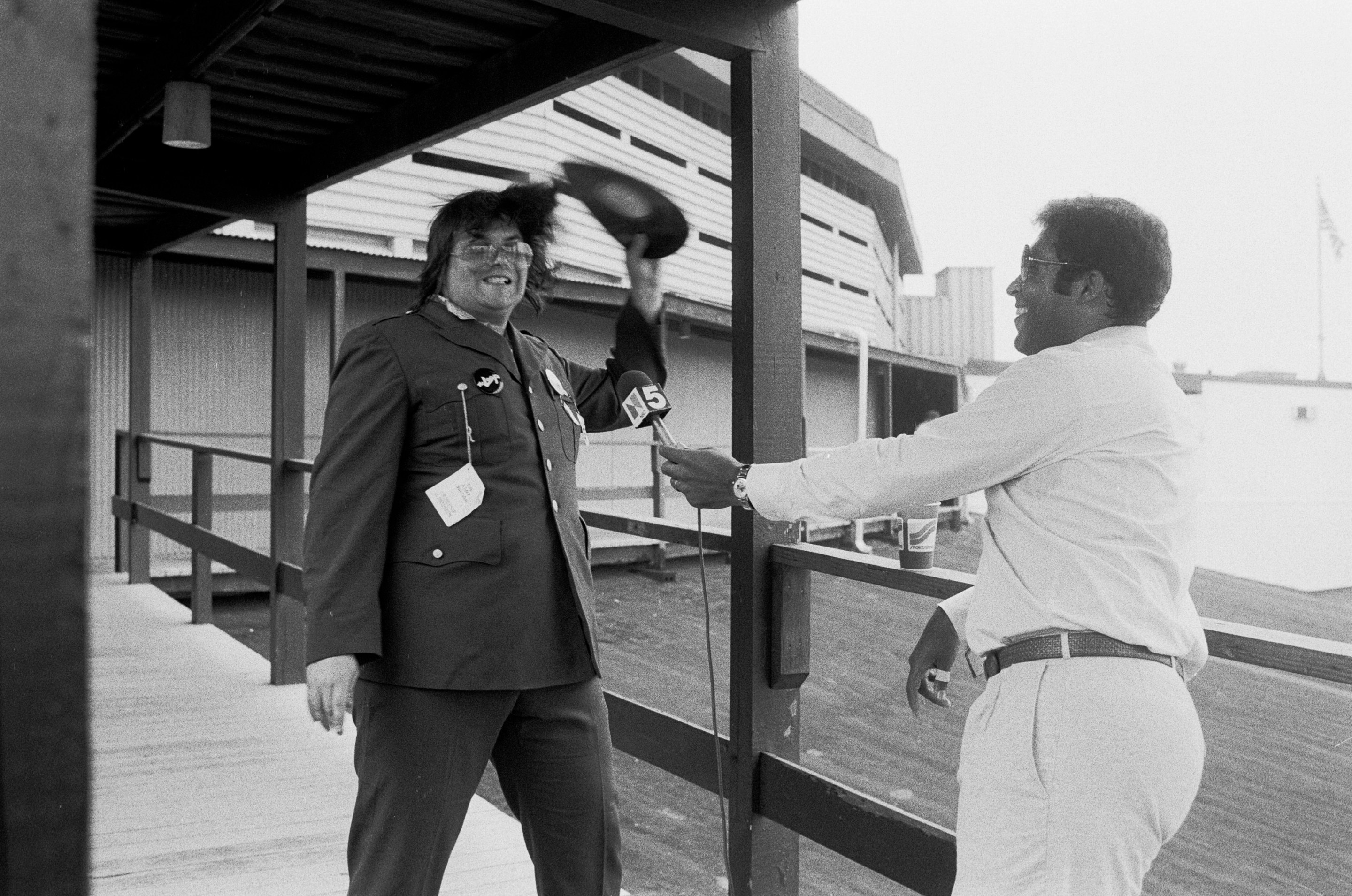 During an interview with sportscaster Greg Gumbel (right), American disc jockey (from WLUP radio, 'The Loop') Steve Dahl breaks a disco record over his head prior to hosting an anti-disco promotion at Comiskey Park, Chicago, Illinois, July 12, 1979. The event, held between games of a doubleheader between the Chicago White Sox and the Detroit Tigers, allowed fans to attend the games for 98 cents along with an unwanted record and, following the detonation of those records, eventually resulted in the White Sox forfeiture of the second game due to unsafe playing conditions when fans stormed the field causing serious damage to the venue and playing surface.