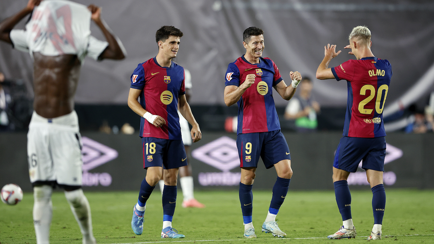 Pau Víctor, Robert Lewandowski, and Dani Olmo celebrate a win against Rayo Vallecano in La Liga.