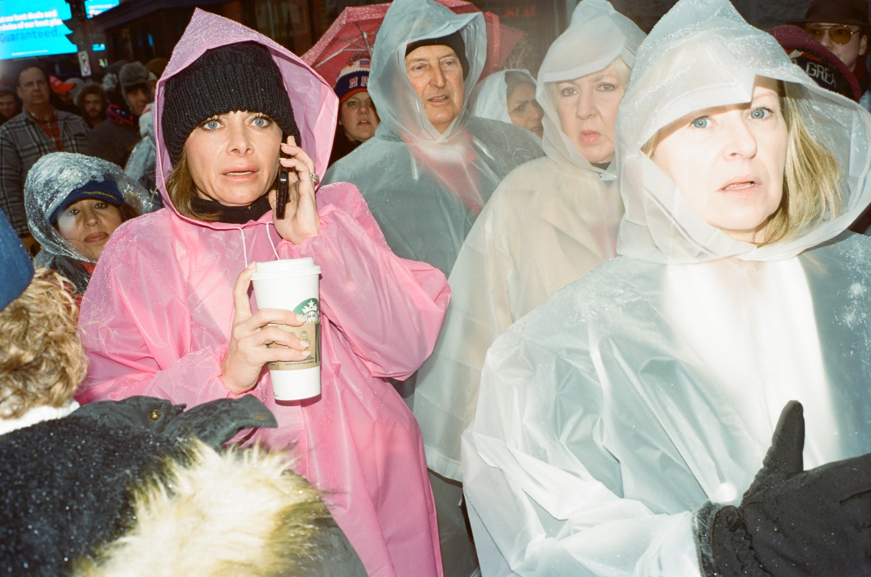 Trump fans in rain ponchos wait in the cold.